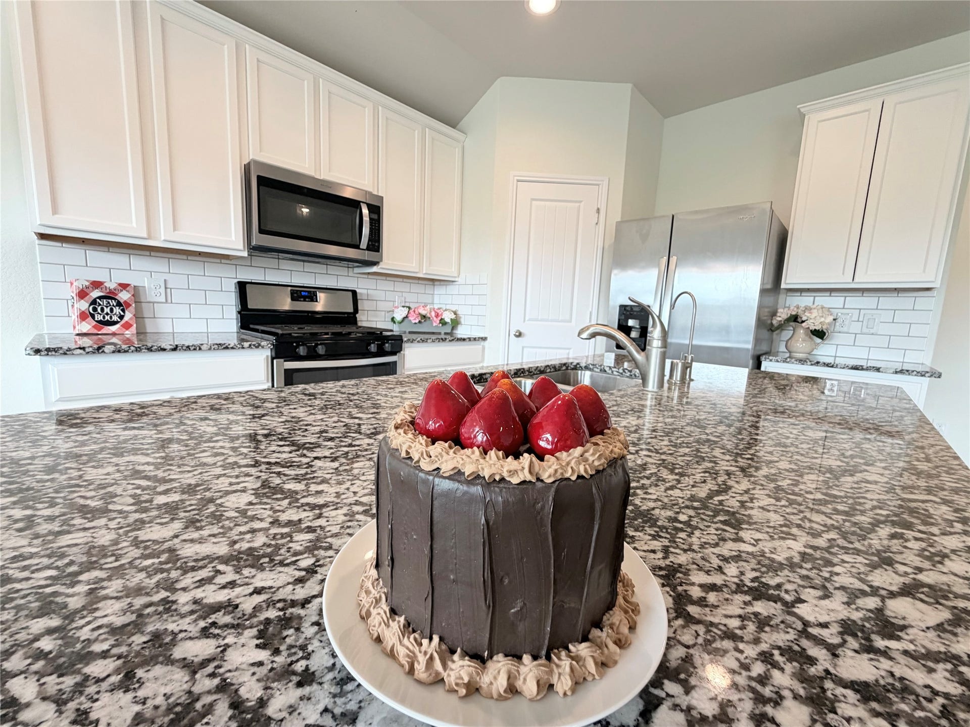 Granite countertops provide abundant workspace for meal preparation and gathering.