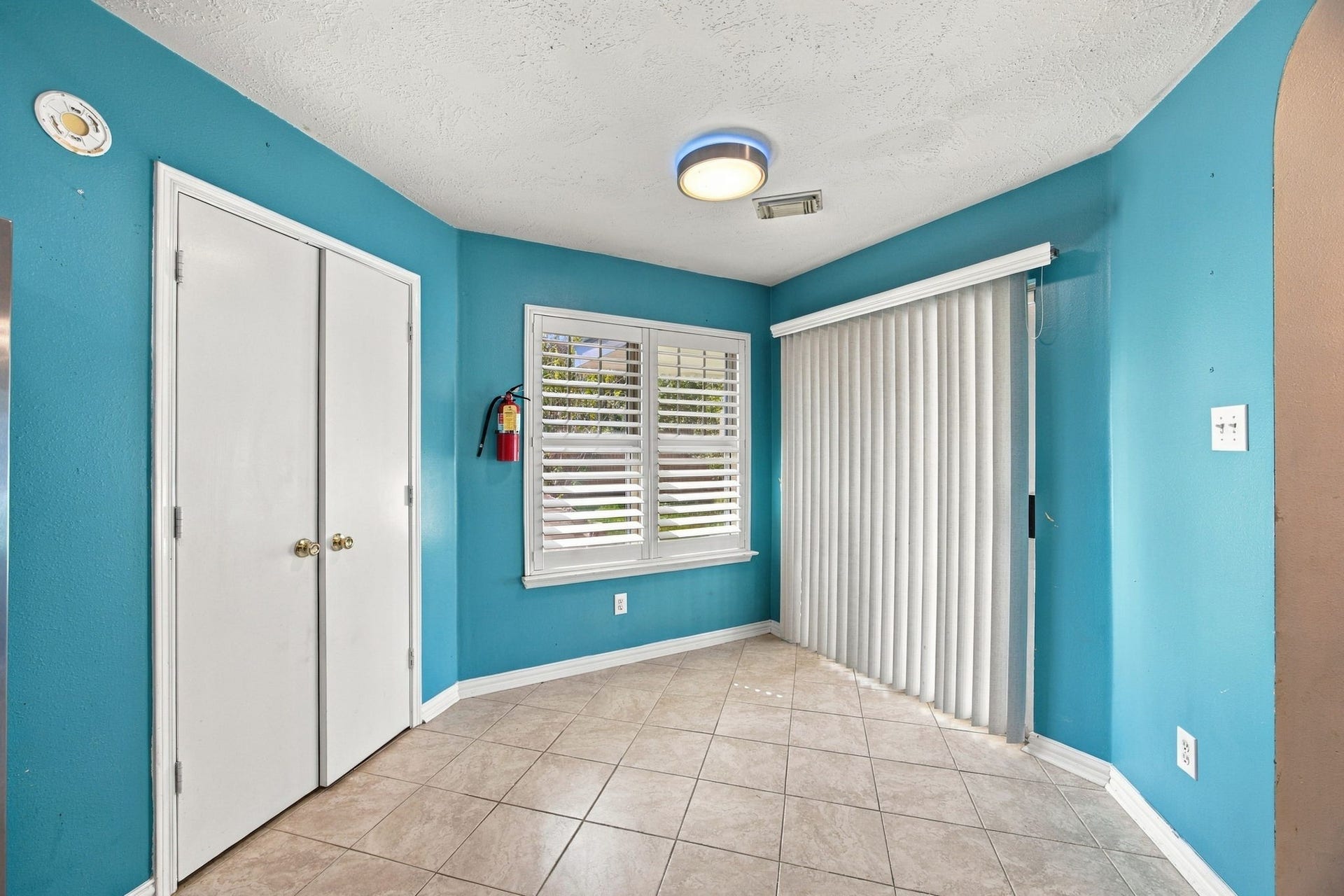 Breakfast room with sliding glass door, leading to covered patio.