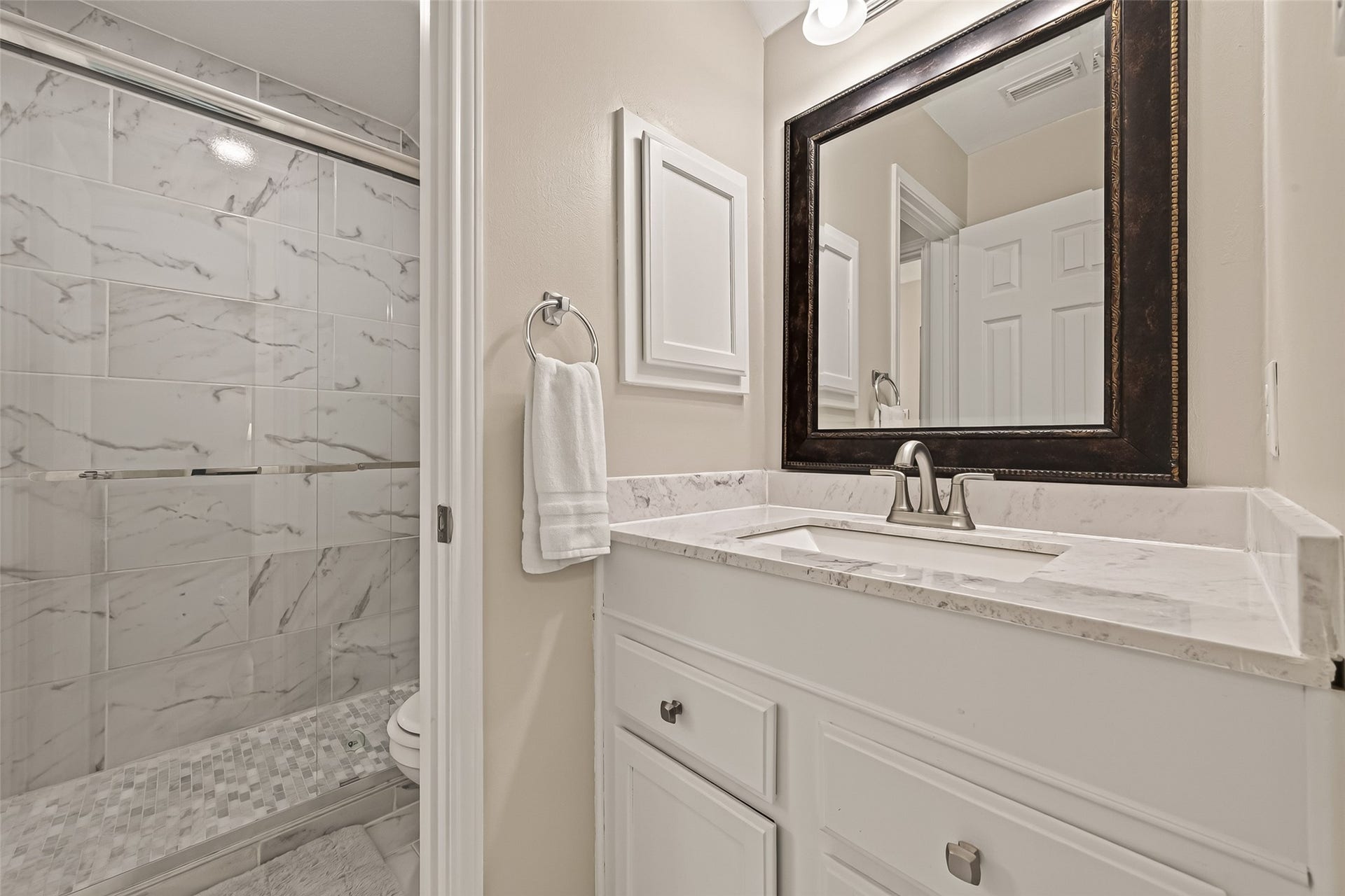 2002 Thorncrest Court, Sugar Land, TX 77479 Elegant bathroom featuring a sleek quarts countertop, modern fixtures, and a spacious glass-enclosed shower with stylish tile work.