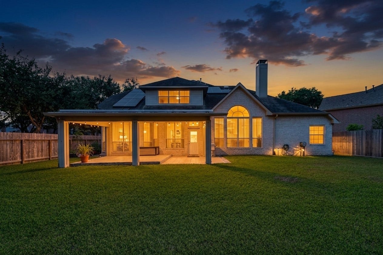 2002 Thorncrest Court, Sugar Land, TX 77479 Charming home with a spacious backyard, featuring a covered patio perfect for outdoor gatherings. The roof is equipped with solar panels for energy efficiency, and the large arched window adds elegance to the exterior.