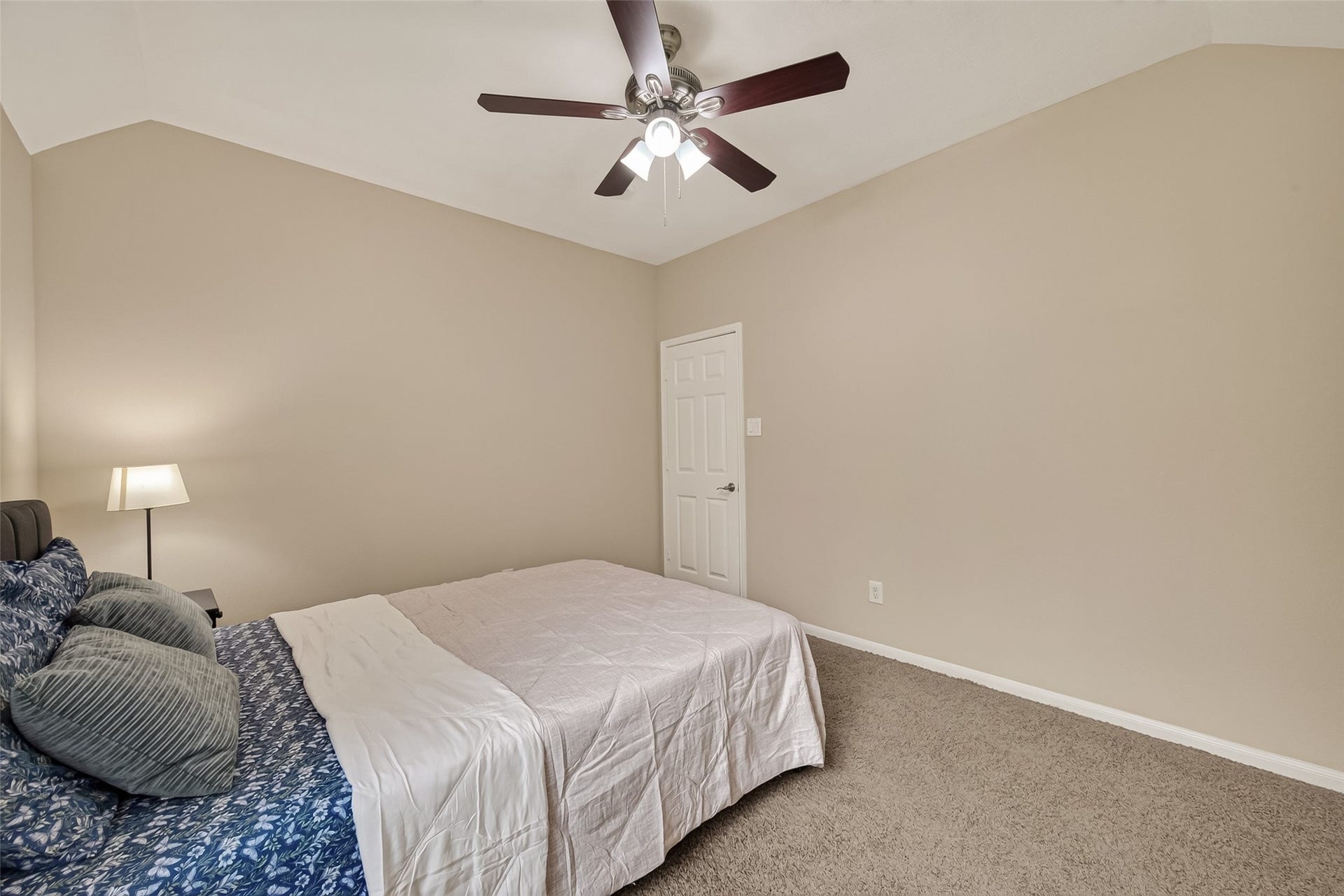2002 Thorncrest Court, Sugar Land, TX 77479 Spacious bedroom featuring neutral tones, plush carpeting, and a ceiling fan for added comfort.