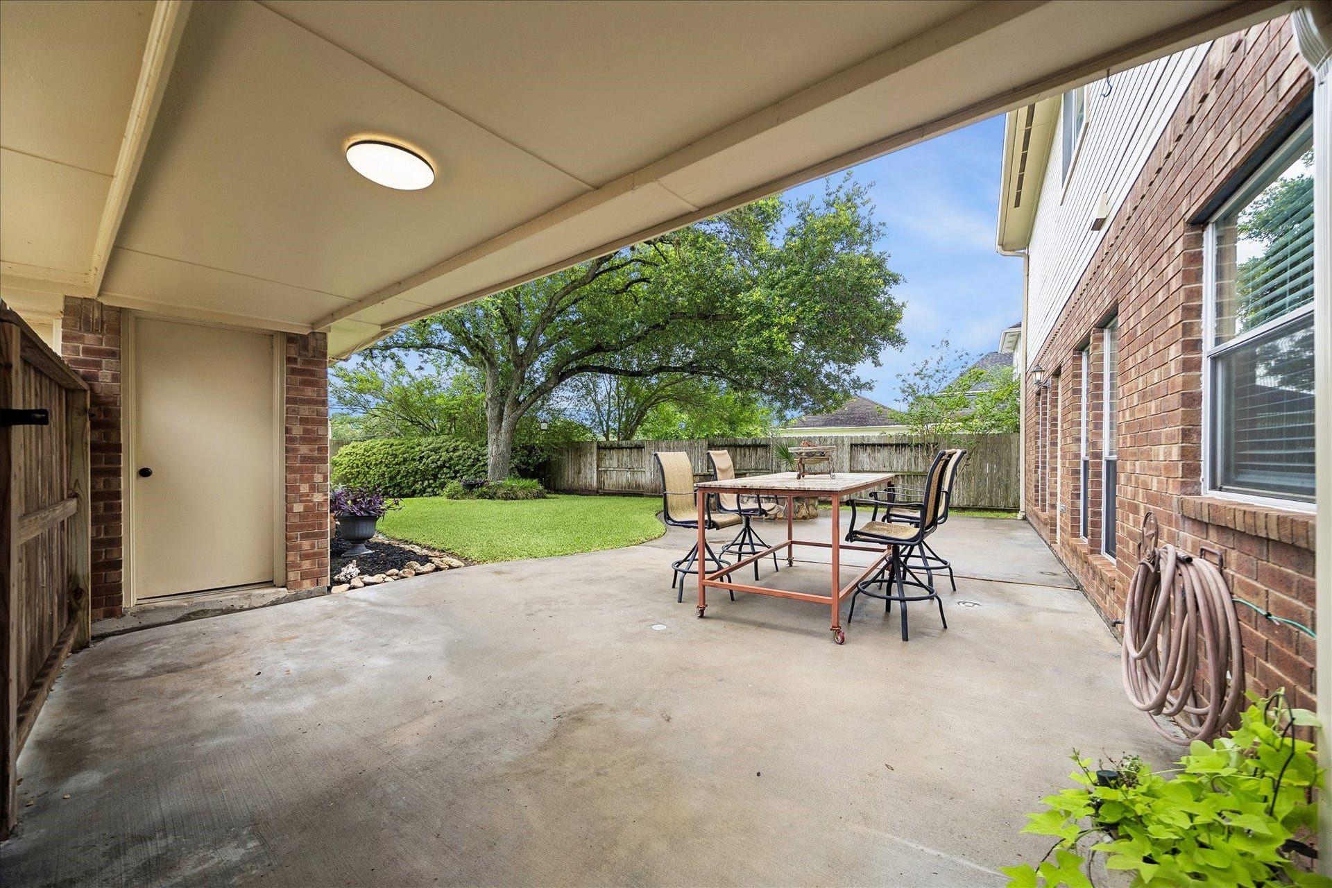 16715 Colony Terrace Drive, Sugar Land, TX 77479 Now, we are walking out the back door from the kitchen. Covered breezeway to the 2 car garage. Huge cement patio.