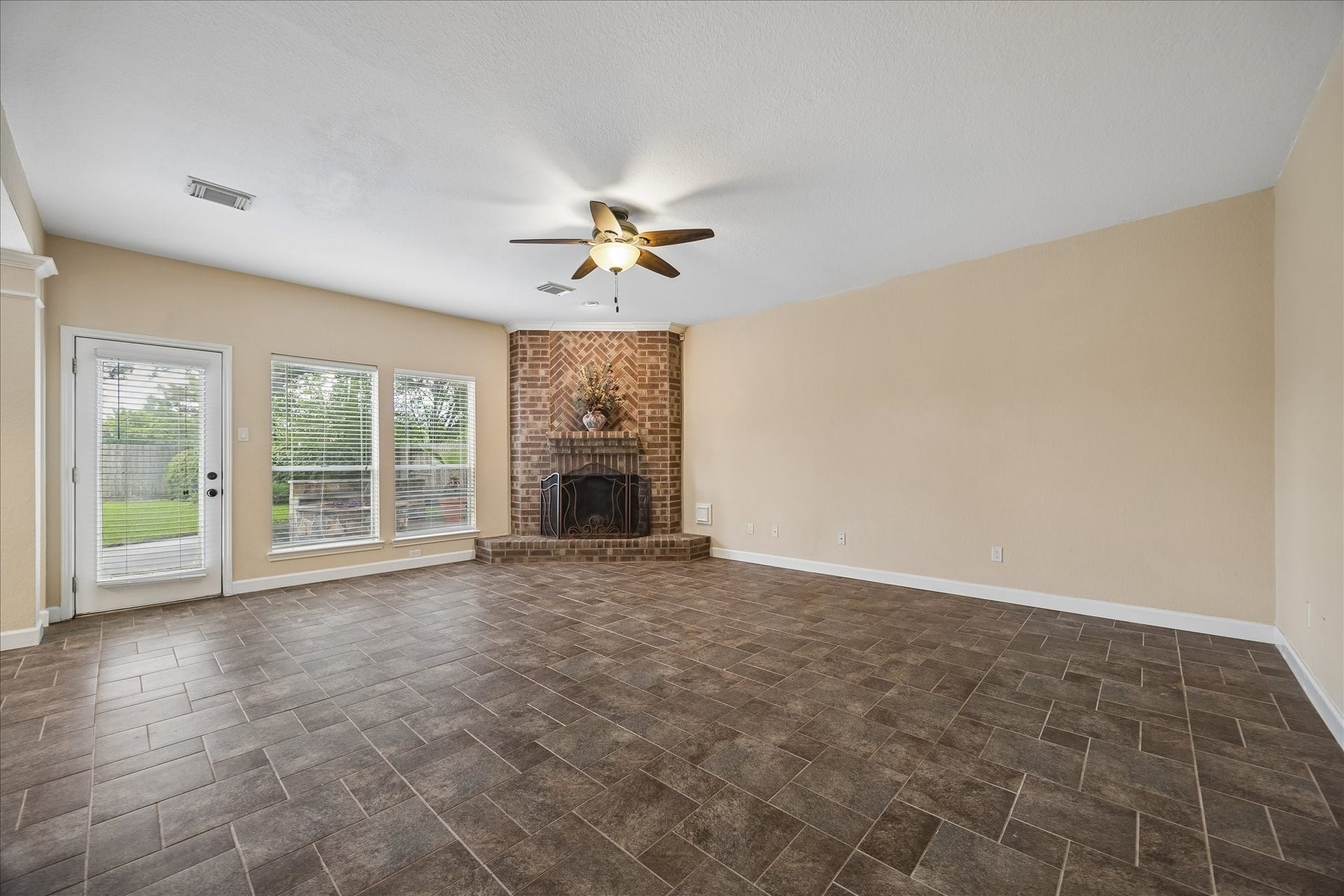 16715 Colony Terrace Drive, Sugar Land, TX 77479 Another view of the family room with elegant brick surround gas fireplace with mantel. There are 2 doors leading to the backyard - no neighborhs behind!