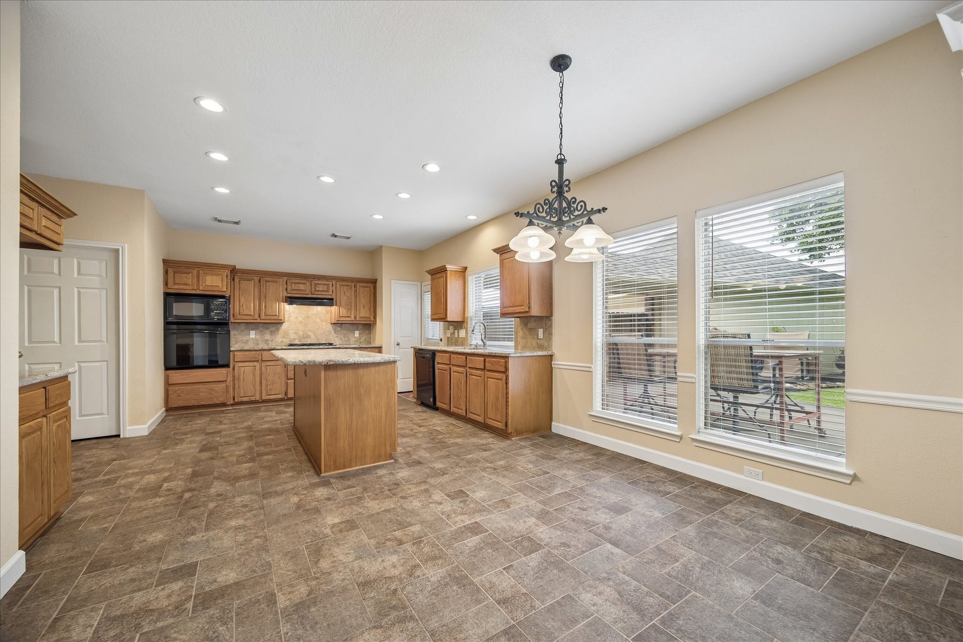 16715 Colony Terrace Drive, Sugar Land, TX 77479 Now lets go from the family room to the breakfast area and then the kitchen. So many windows to keep it bright. The back wall features lots of cabinets and storage microwave, convection oven and gas cooktop.