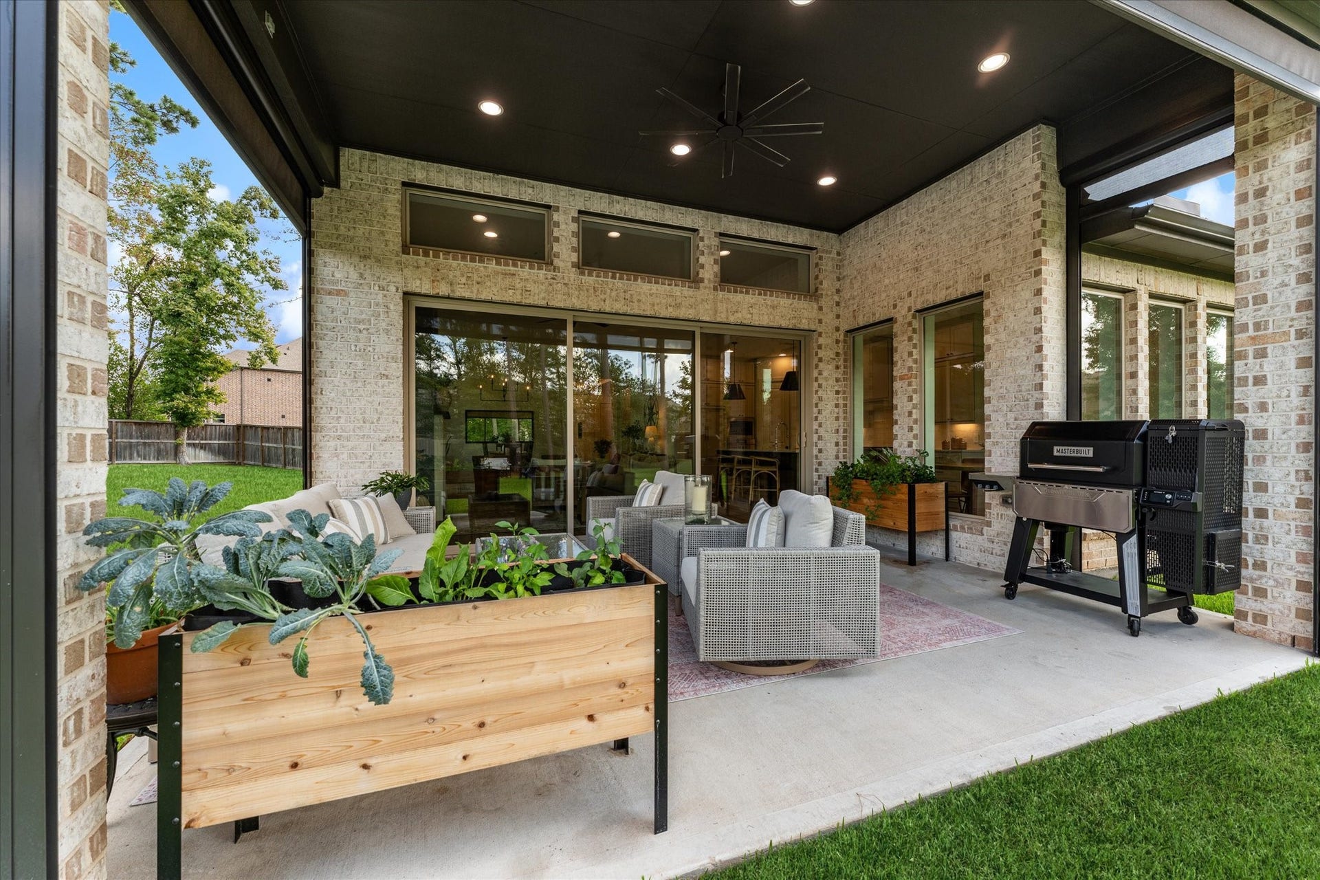 607 Starlit Sky Court, Willis, TX 77318 Extended covered patio complete with remote screens