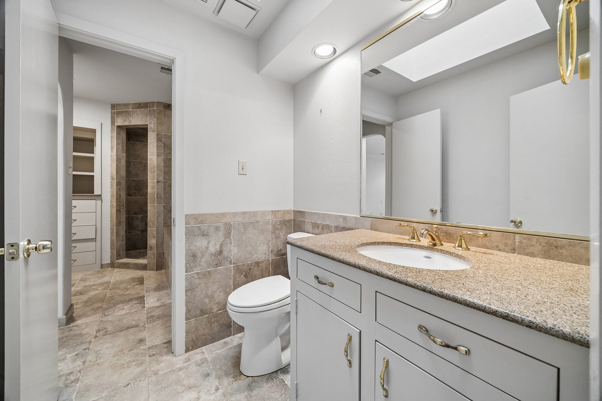 10327 Olympia Drive, Houston, TX 77042 The en-suite bath features stone counter top, large soaking tub and separate shower.