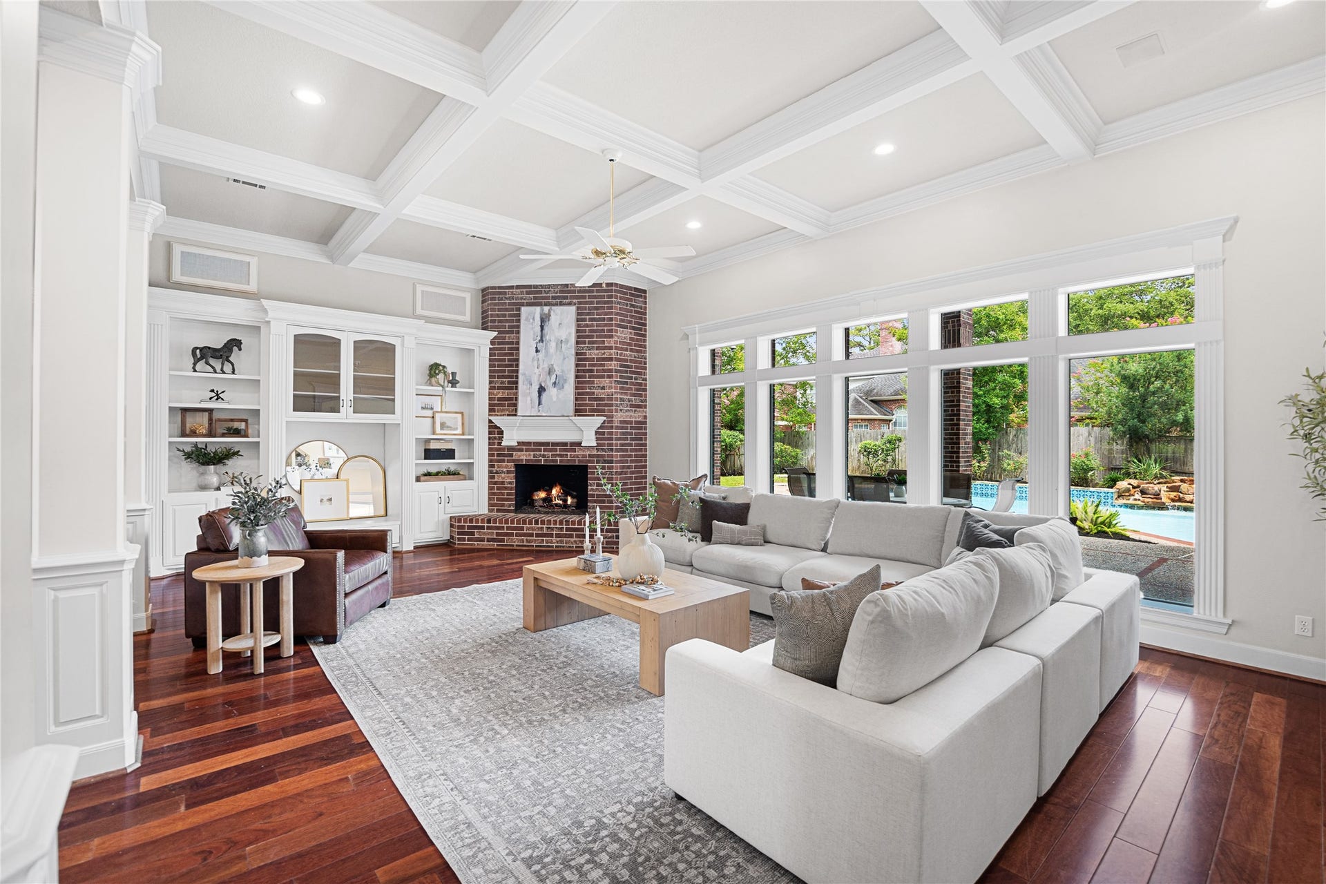 11822 Primwood Drive, Houston, TX 77070 Inviting family room with coffered ceilings, custom built-ins, and fireplace.