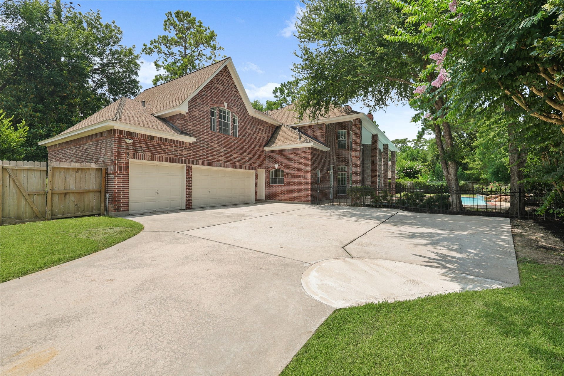 11822 Primwood Drive, Houston, TX 77070 Gated driveway with oversized parking and three-car garage.