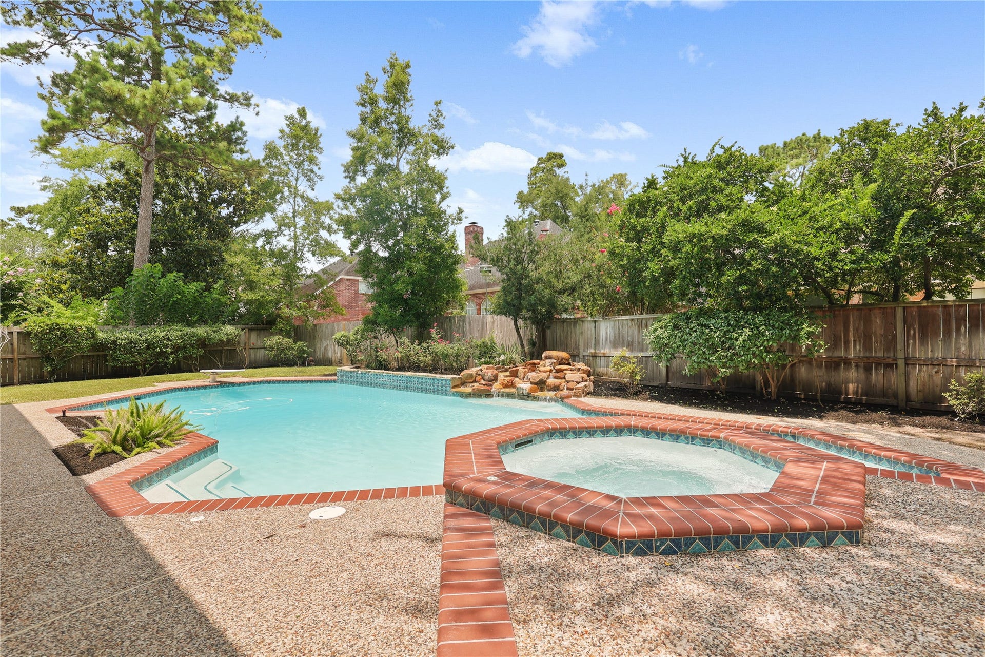 11822 Primwood Drive, Houston, TX 77070 Pool and spa with peaceful rock waterfall feature.