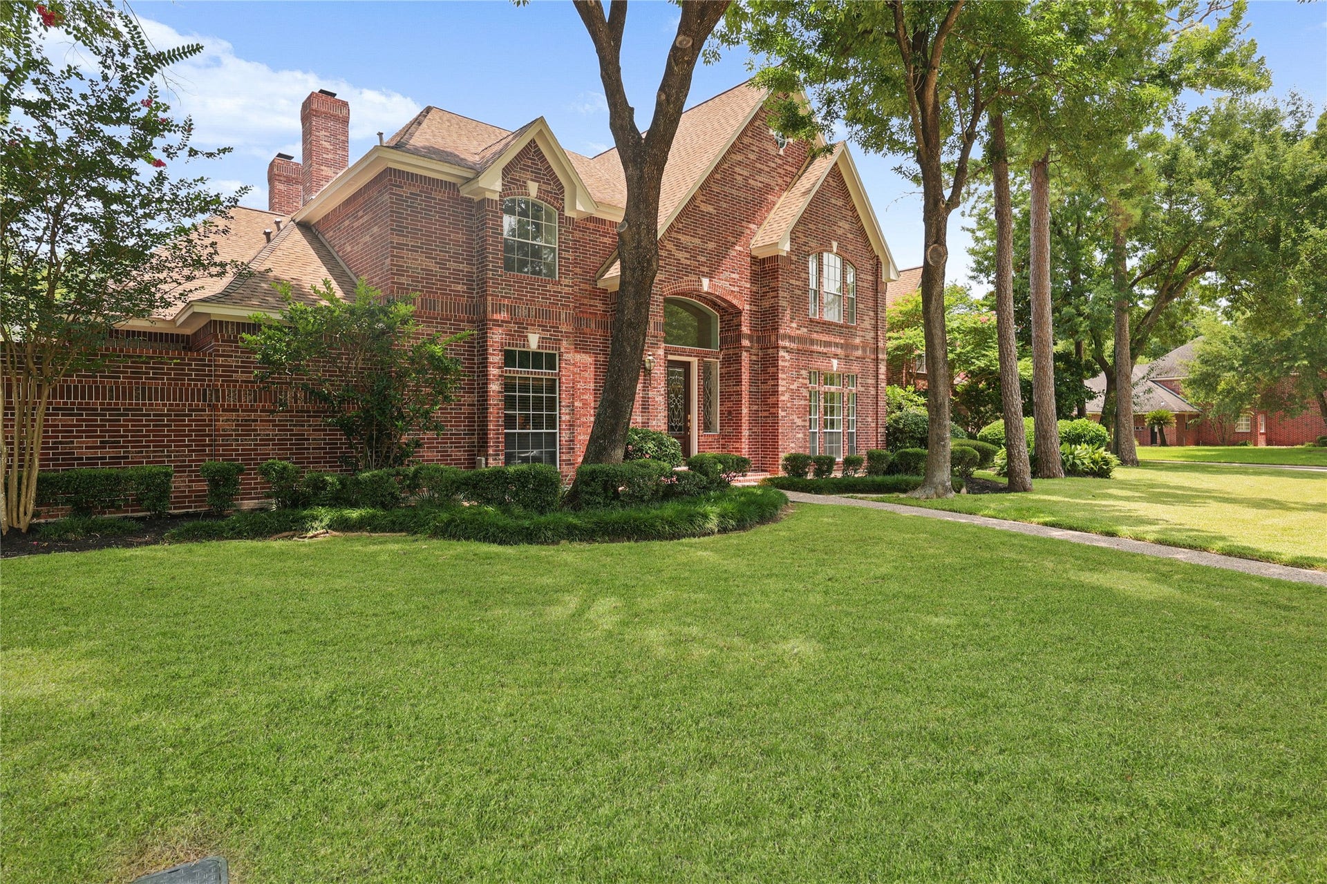 11822 Primwood Drive, Houston, TX 77070 Grand front elevation showcasing elegant design on an oversized corner lot.
