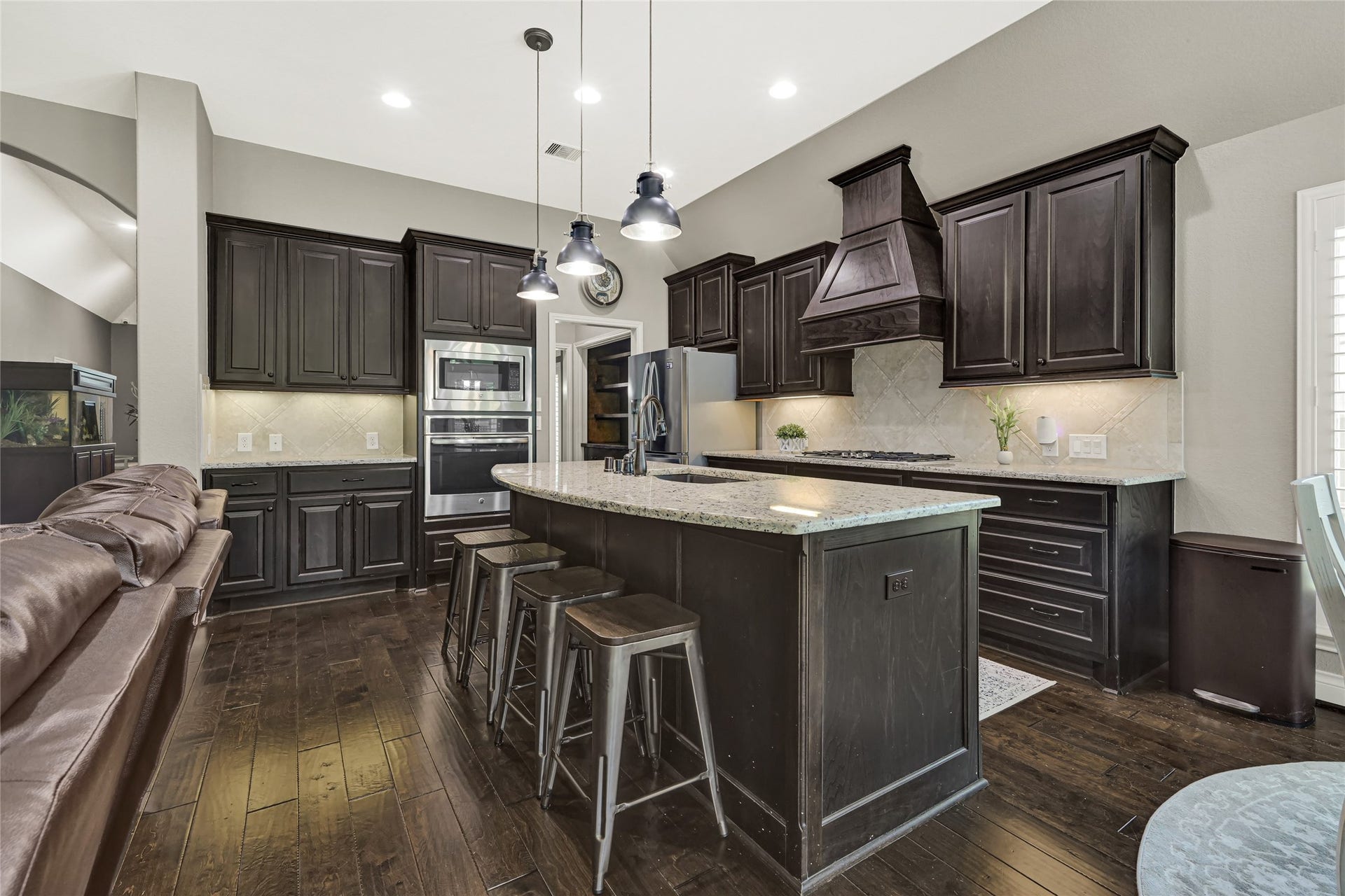 Discover a kitchen brimming with ample cabinetry and a modern refrigerator included, perfect for culinary endeavors and stylish storage.