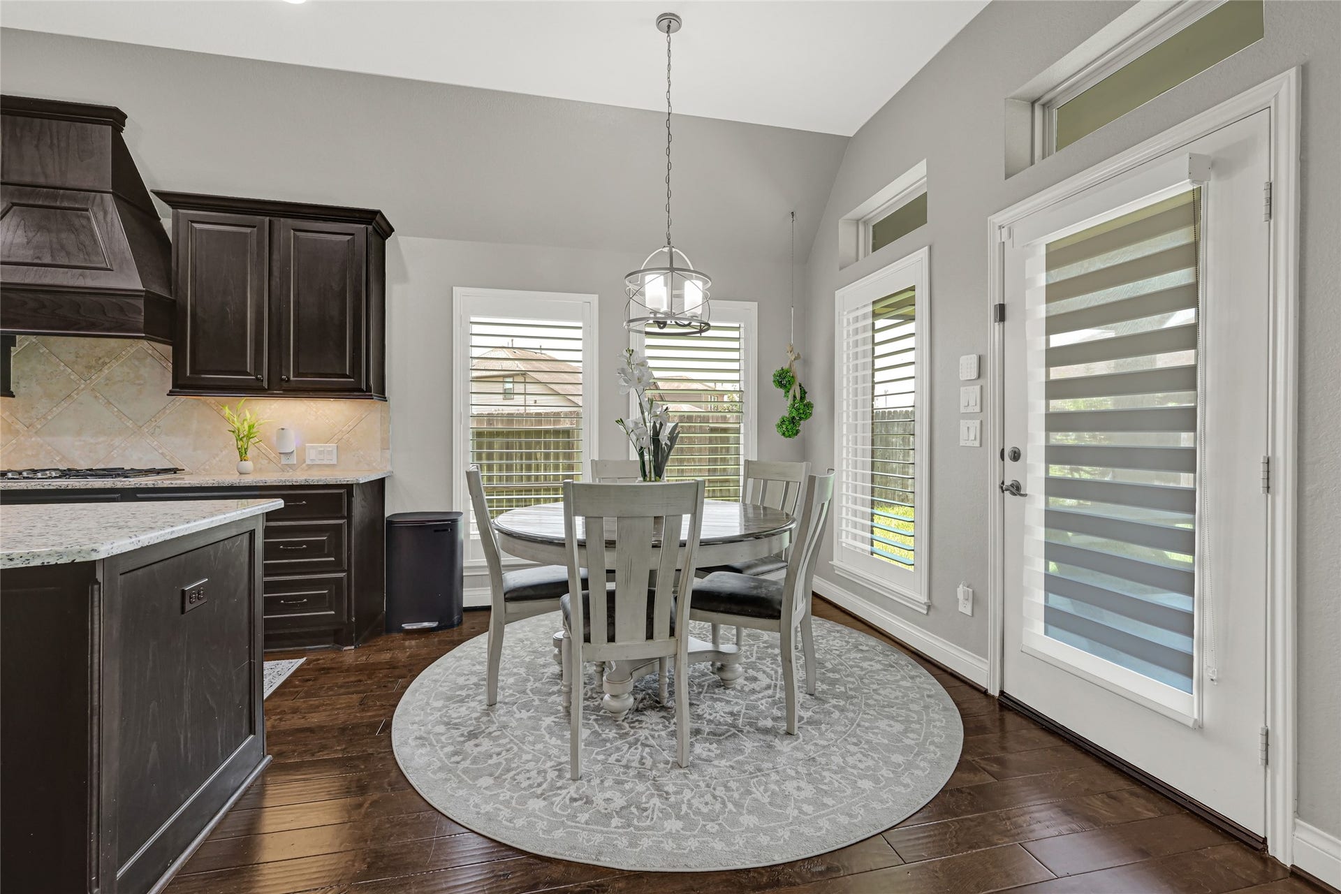 Start your mornings in a cozy breakfast nook where family laughter fills the air, surrounded by natural light and elegant finishes by plantation shutter window treatment.