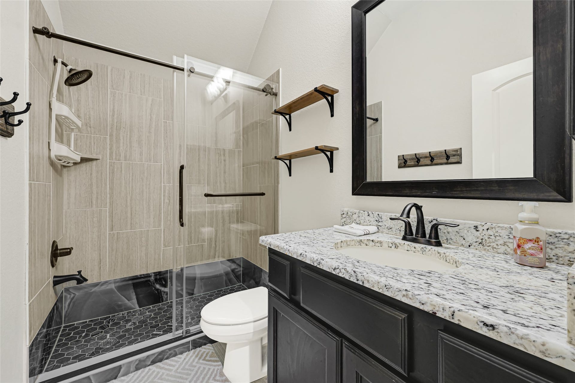 This modern luxury bath offers sliding door walk-in shower is conveniently between 2 bedrooms