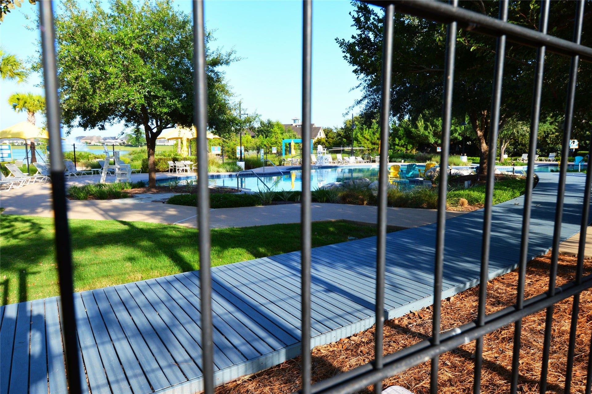 Dive into relaxation and community fun at this stunning pool oasis, surrounded by lush greenery and inviting lounging areas.