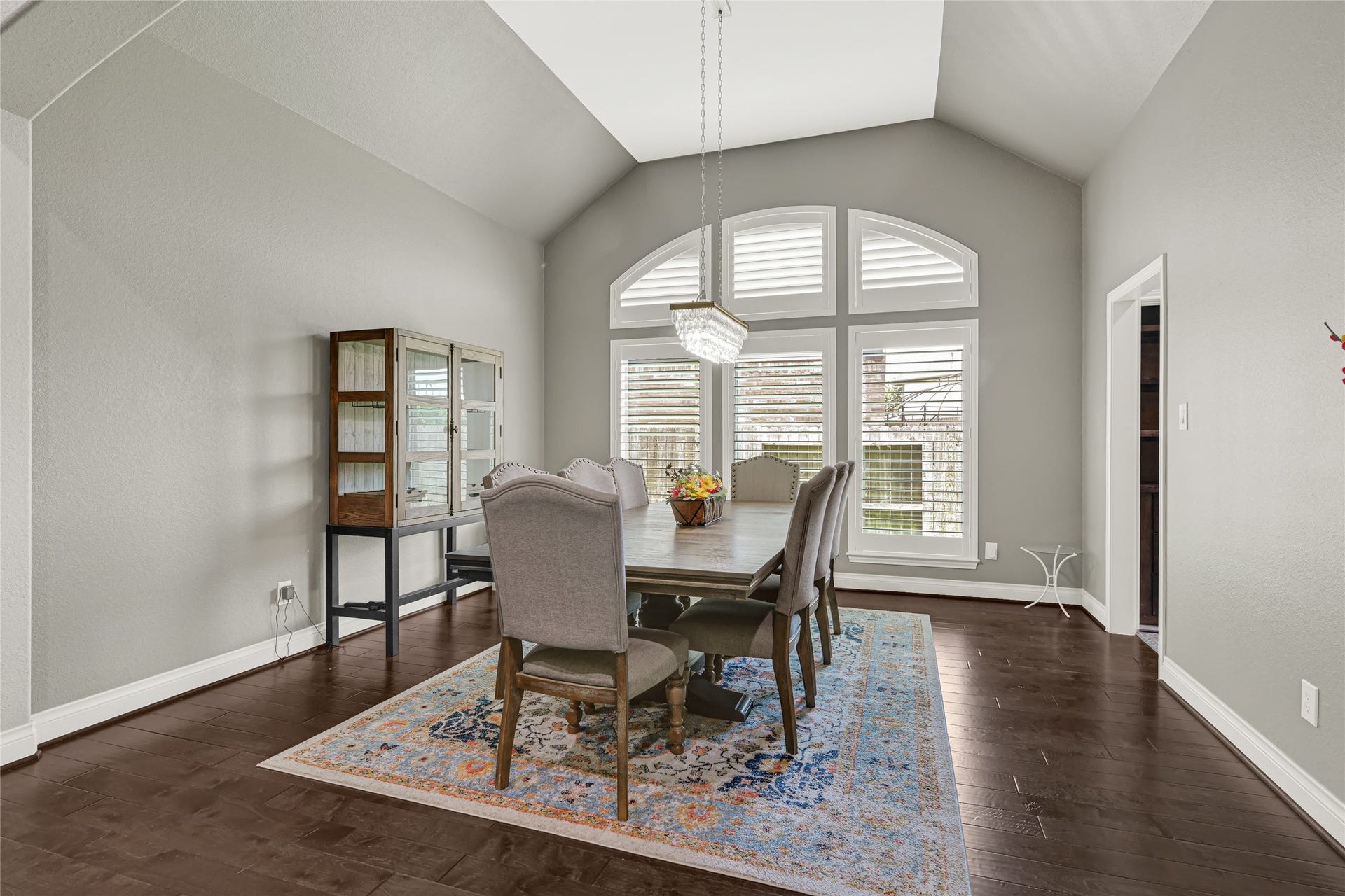 Elegant and spacious formal dining room, perfect for holiday gatherings, with abundant natural light through Plantation shutter