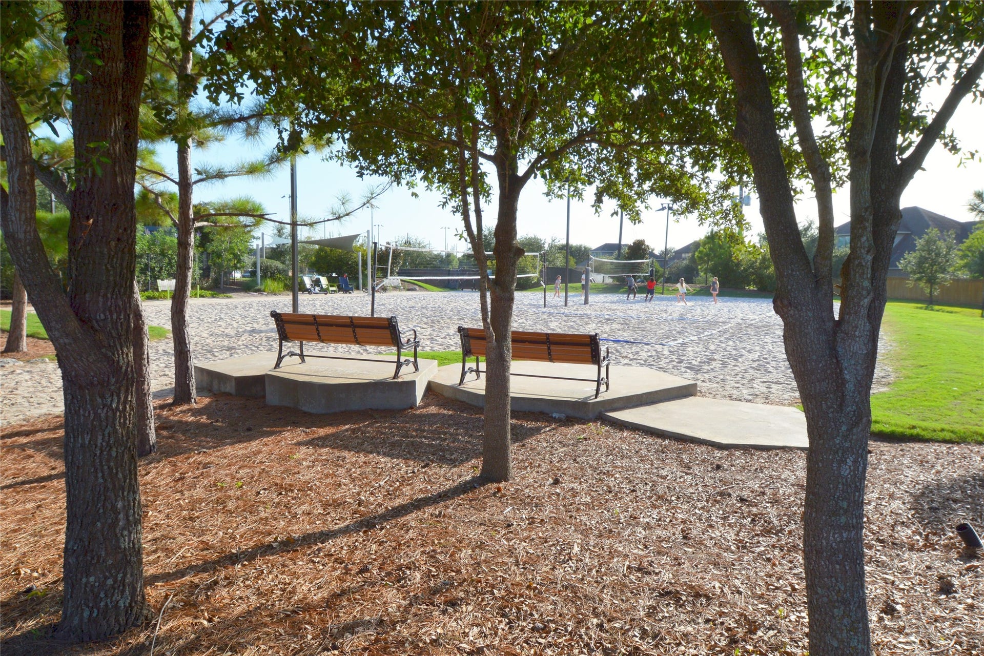 Enjoy vibrant community living with this inviting volleyball court nestled among lush greenery, perfect for friendly matches and outdoor relaxation.