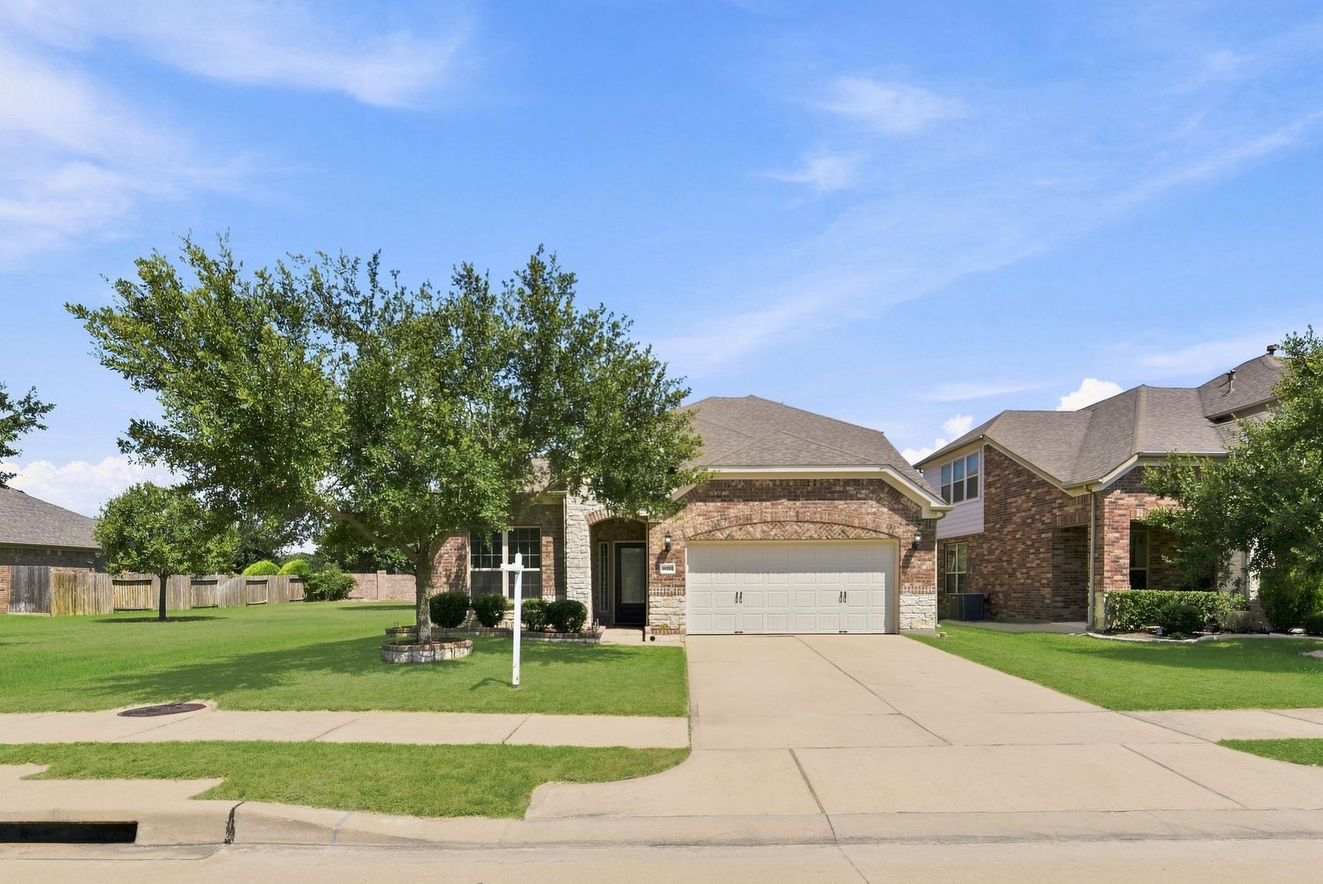 25322 Alverstone Drive, Katy, TX 77494 Charming brick ONLY ONE SIDE NEIGHBOR home with a spacious driveway, two-car garage, and lush front yard framed by mature trees.