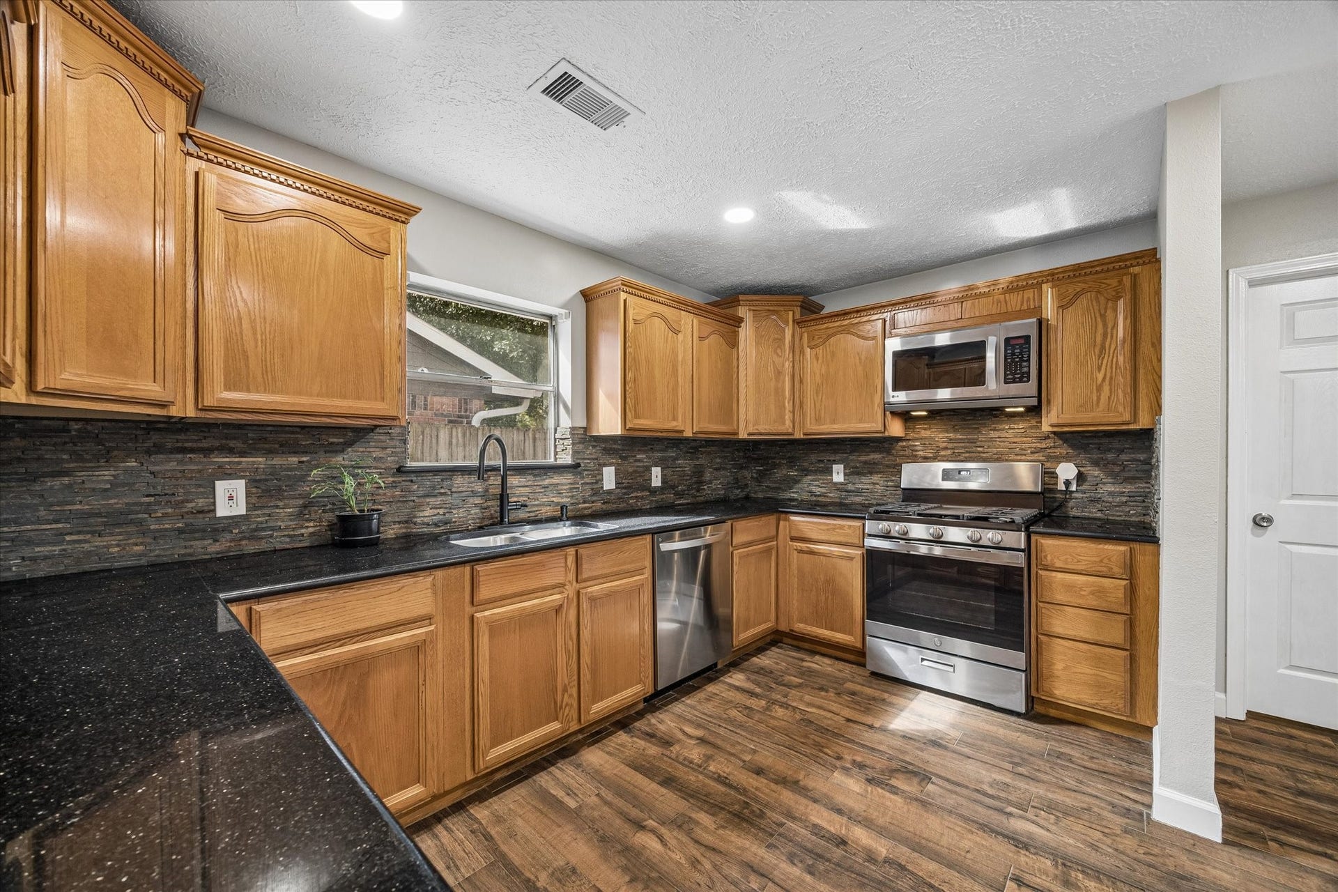 The kitchen offers plenty of room for meal prep, with ample workspace and storage to make cooking and entertaining a breeze.