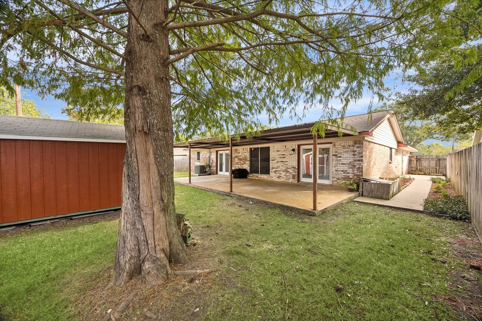 Beautifully designed backyard featuring a spacious, oversized covered patio, perfect for outdoor entertaining and year-round relaxation.