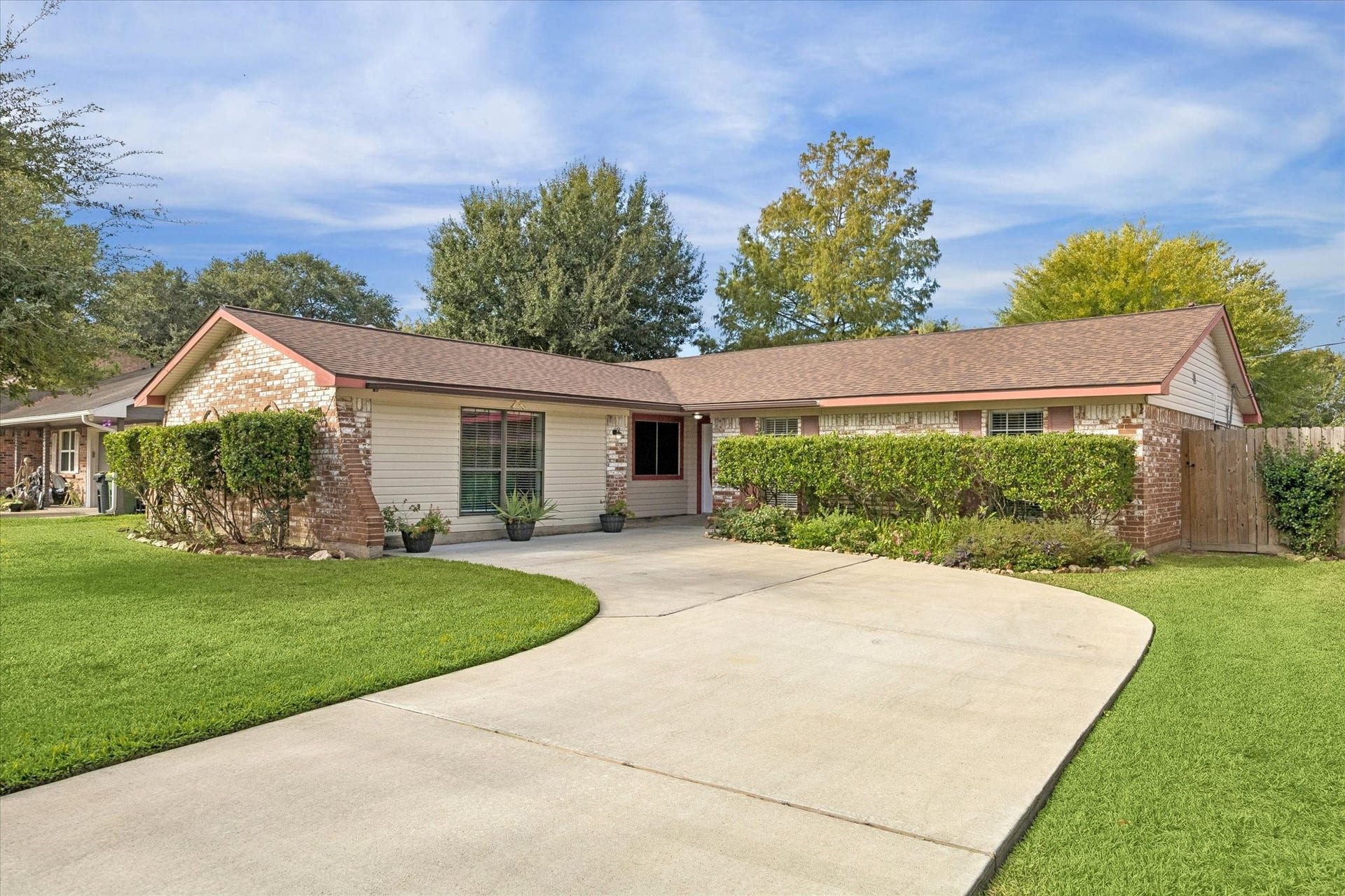 The spacious, newer driveway provides ample parking, while the two-year-old roof adds peace of mind. The timeless brick exterior and attractive landscaping create excellent curb appeal.