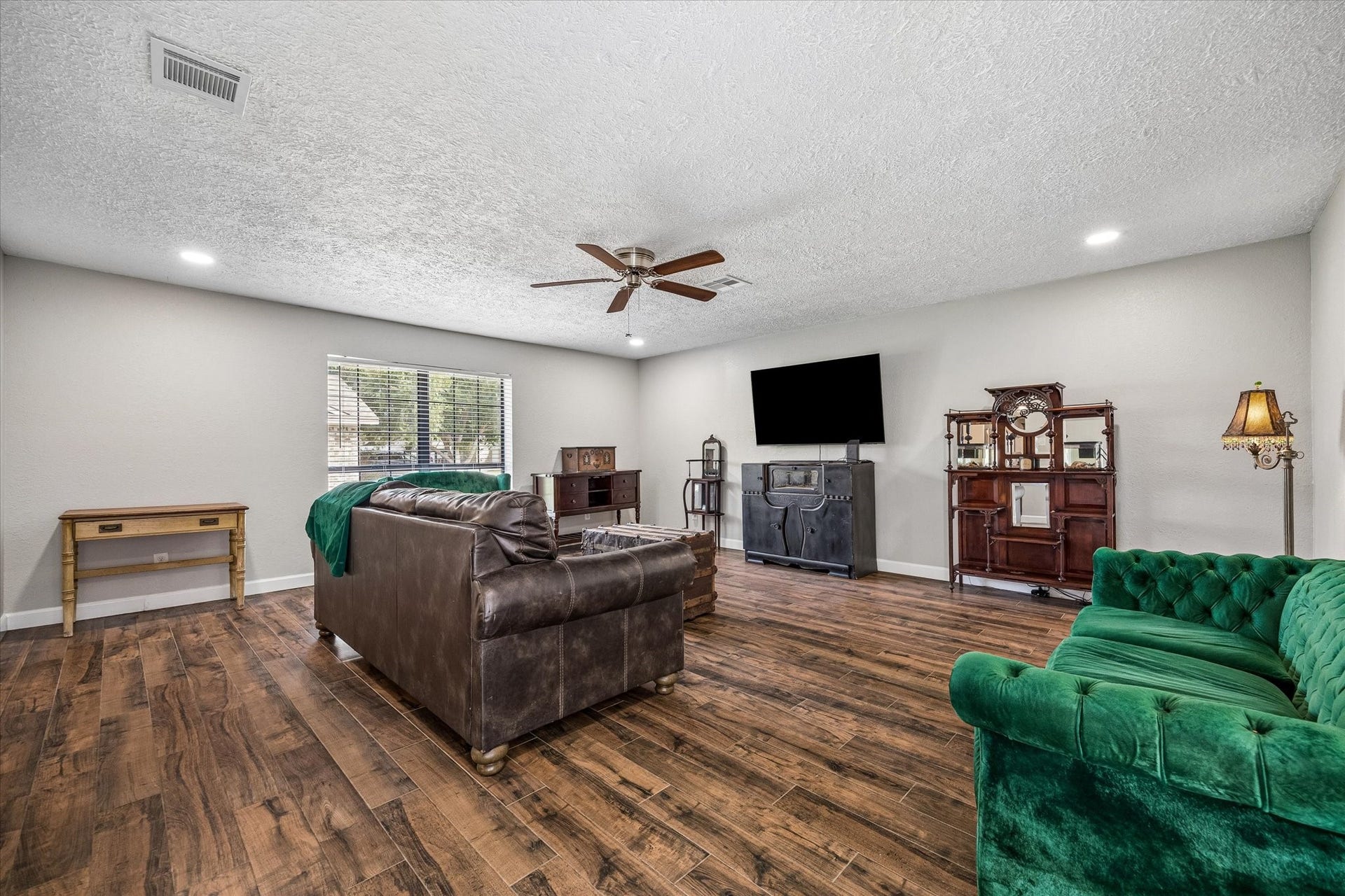 Updated recessed lighting brightens the space and adds a modern touch, enhancing comfort and functionality for everyday living.