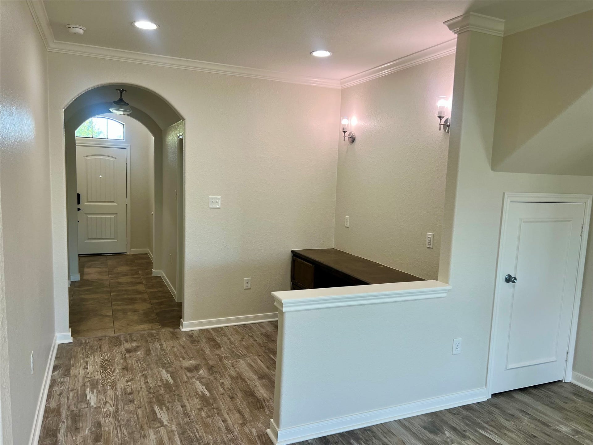 Living area looking towards front door.  Nice arches and art niche in entry.
