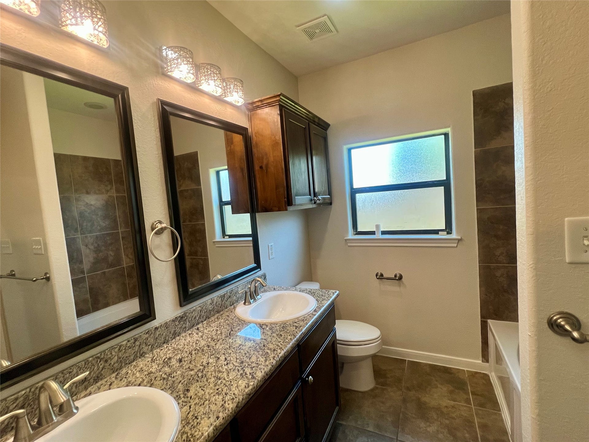 Primary bath with double sinks, separate shower and tub.
