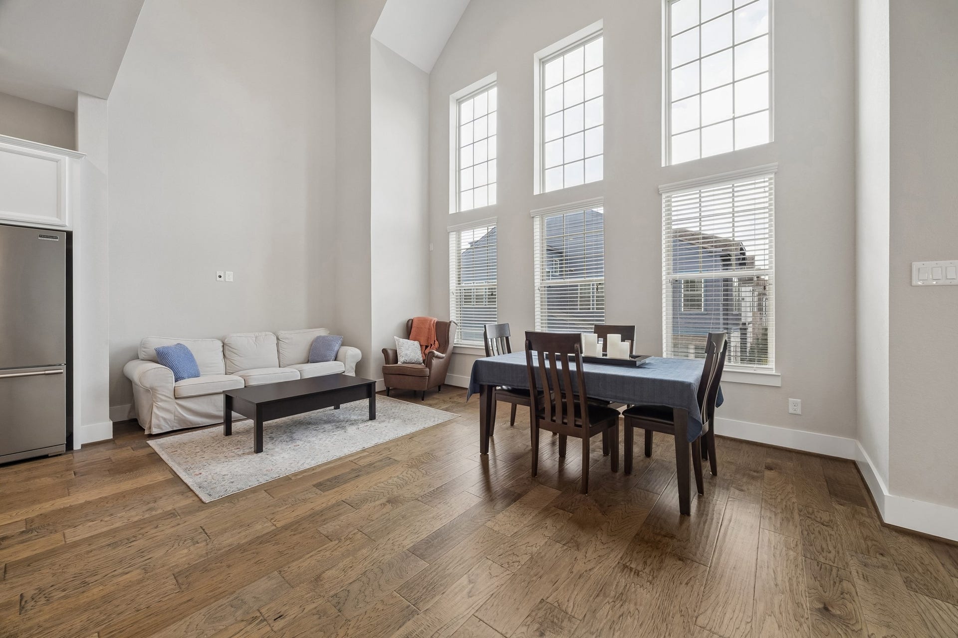 The main living area features soaring ceilings and beautiful engineered wood flooring, creating an open and inviting atmosphere.