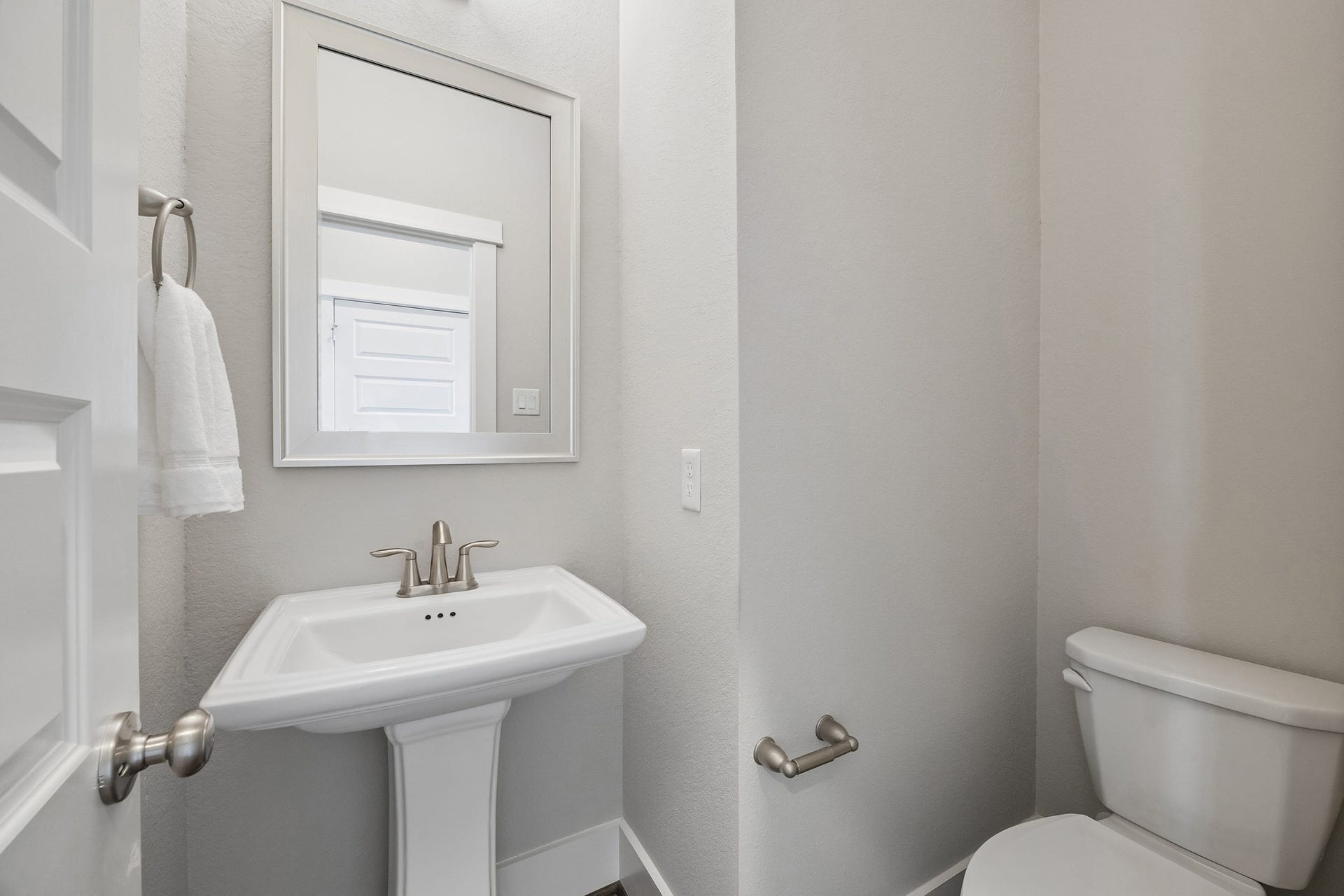 A well-appointed powder bath offers both style and convenience for guests.