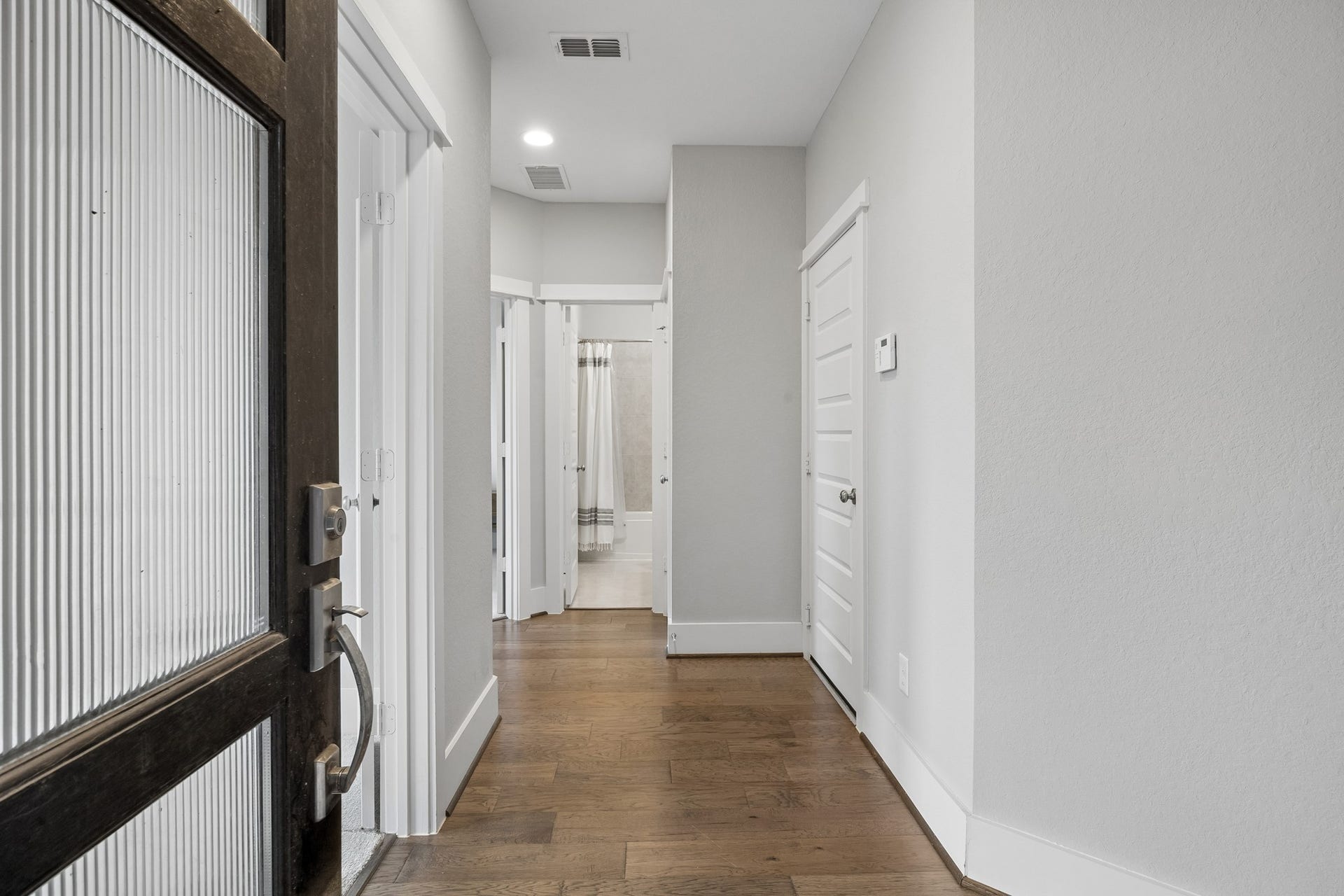 Upon entering the home, you're welcomed by a bright and inviting entryway enhanced by beautiful engineered wood flooring.