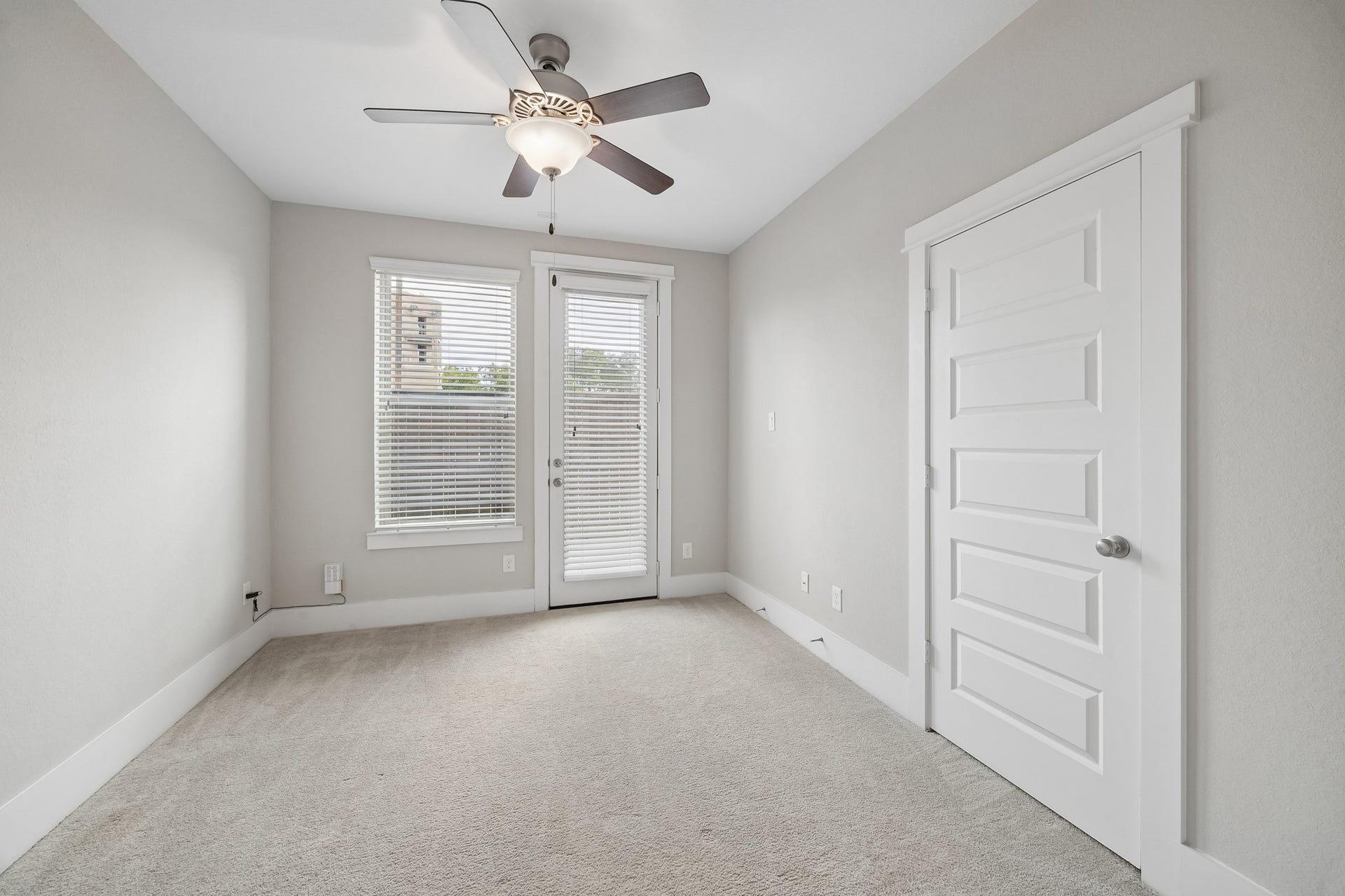 One of two bedrooms located on the first floor, this well-appointed space offers the perfect blend of comfort and flexibility for guests, remote work, or everyday living.