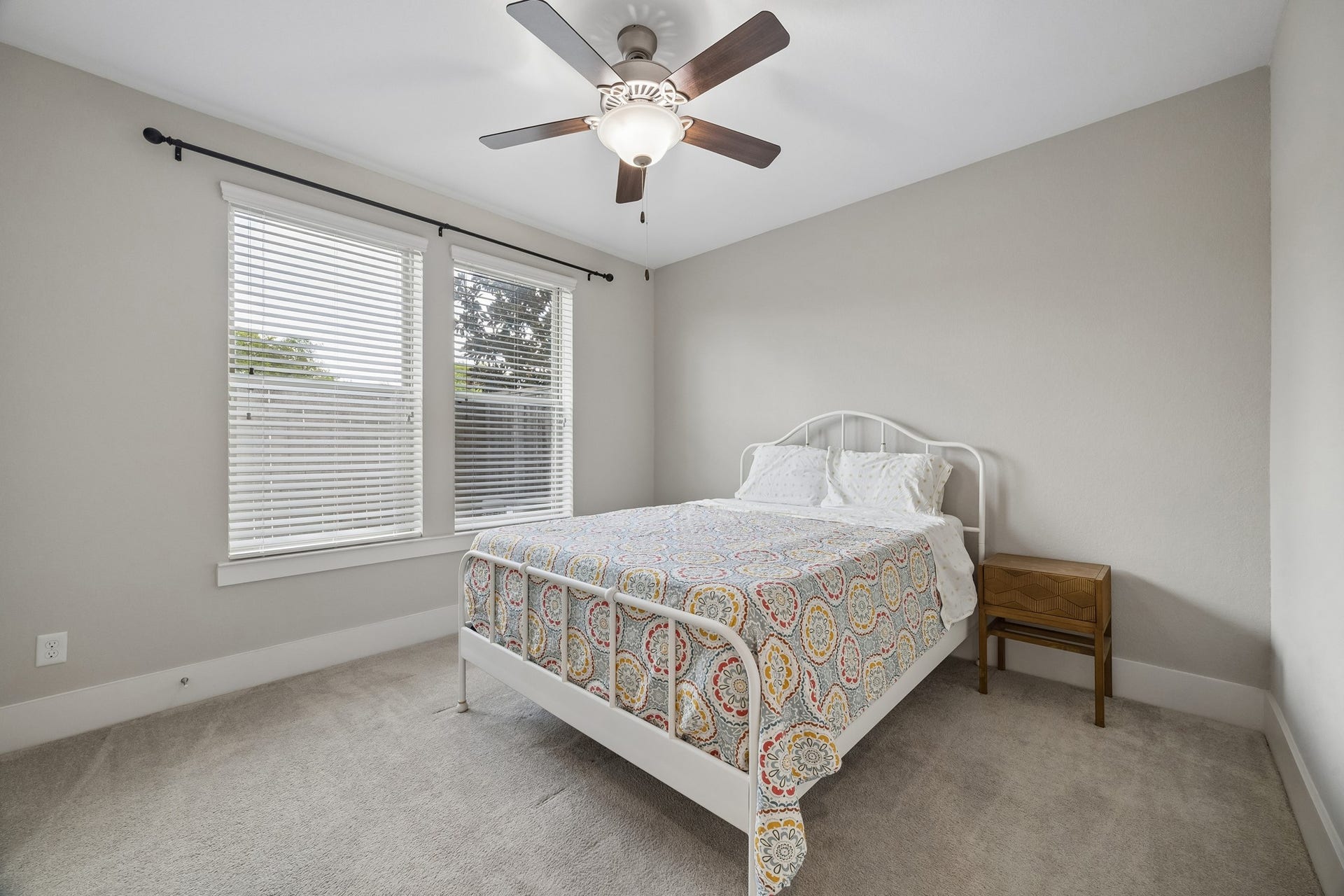 This is the second downstairs bedroom, offering the flexibility to serve as a guest room, home office, or private workspace.
