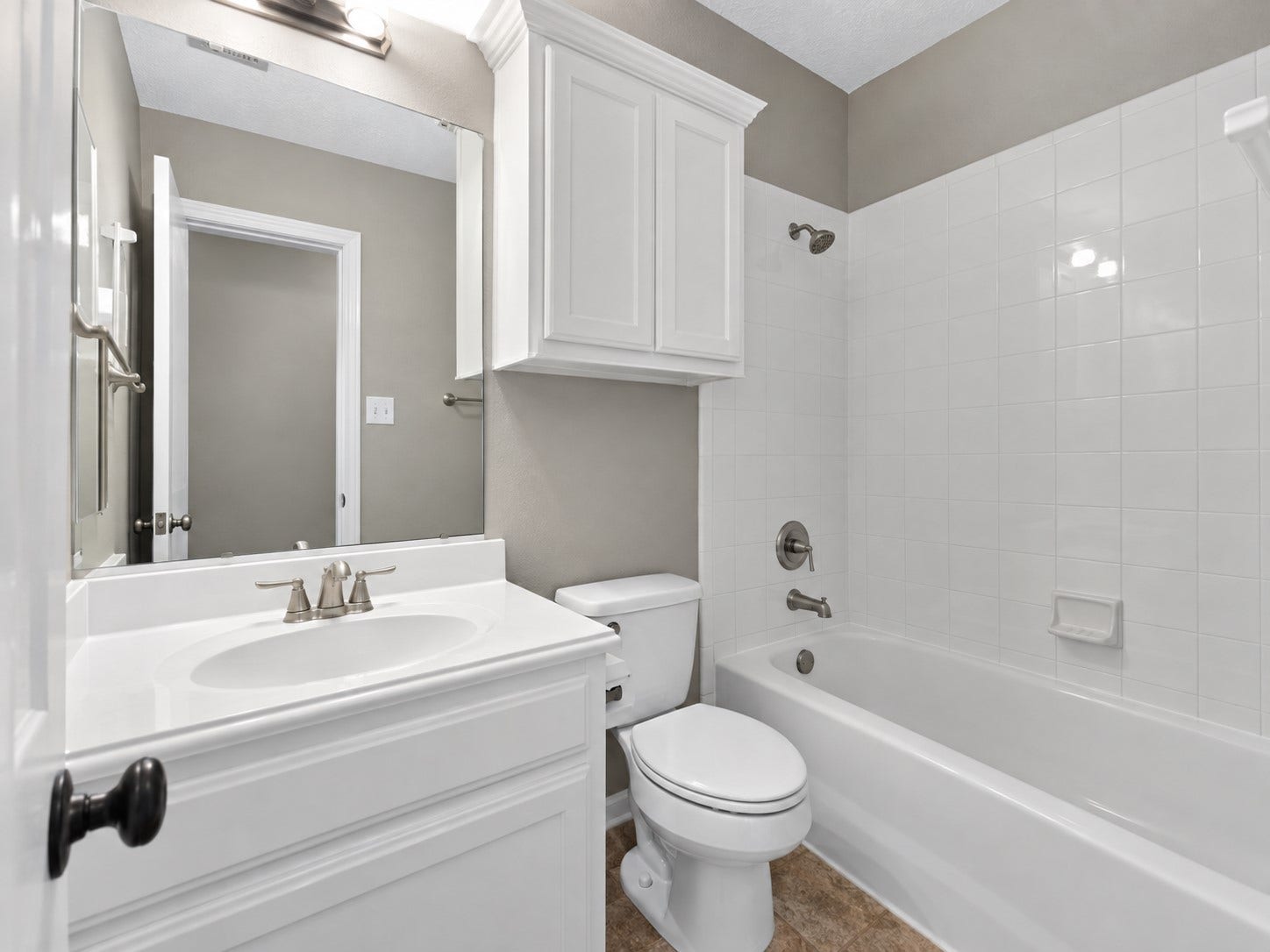 11810 Rue Beaujon Court, Tomball, TX 77377 Private ensuite bath with bright white cabinetry and a tub/shower combination.
