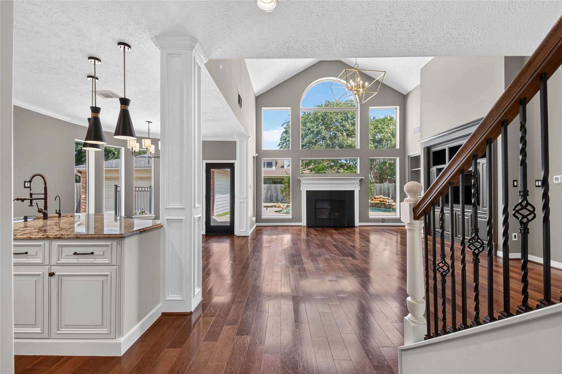 11810 Rue Beaujon Court, Tomball, TX 77377 REAL WOOD FLOORS lead into the impressive two-story family room filled with natural light and backyard views.