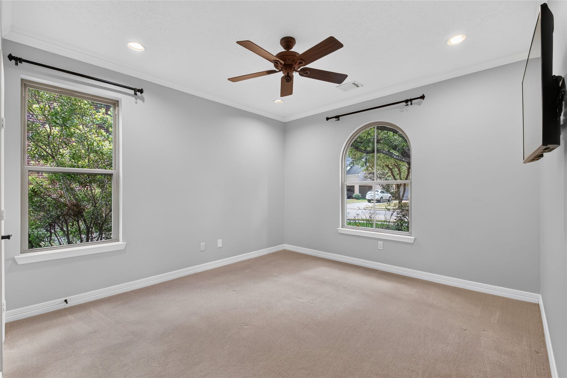 11810 Rue Beaujon Court, Tomball, TX 77377 Second Bedroom down with an arched window and convenient access to a full bathideal for guests or multi-generational living.