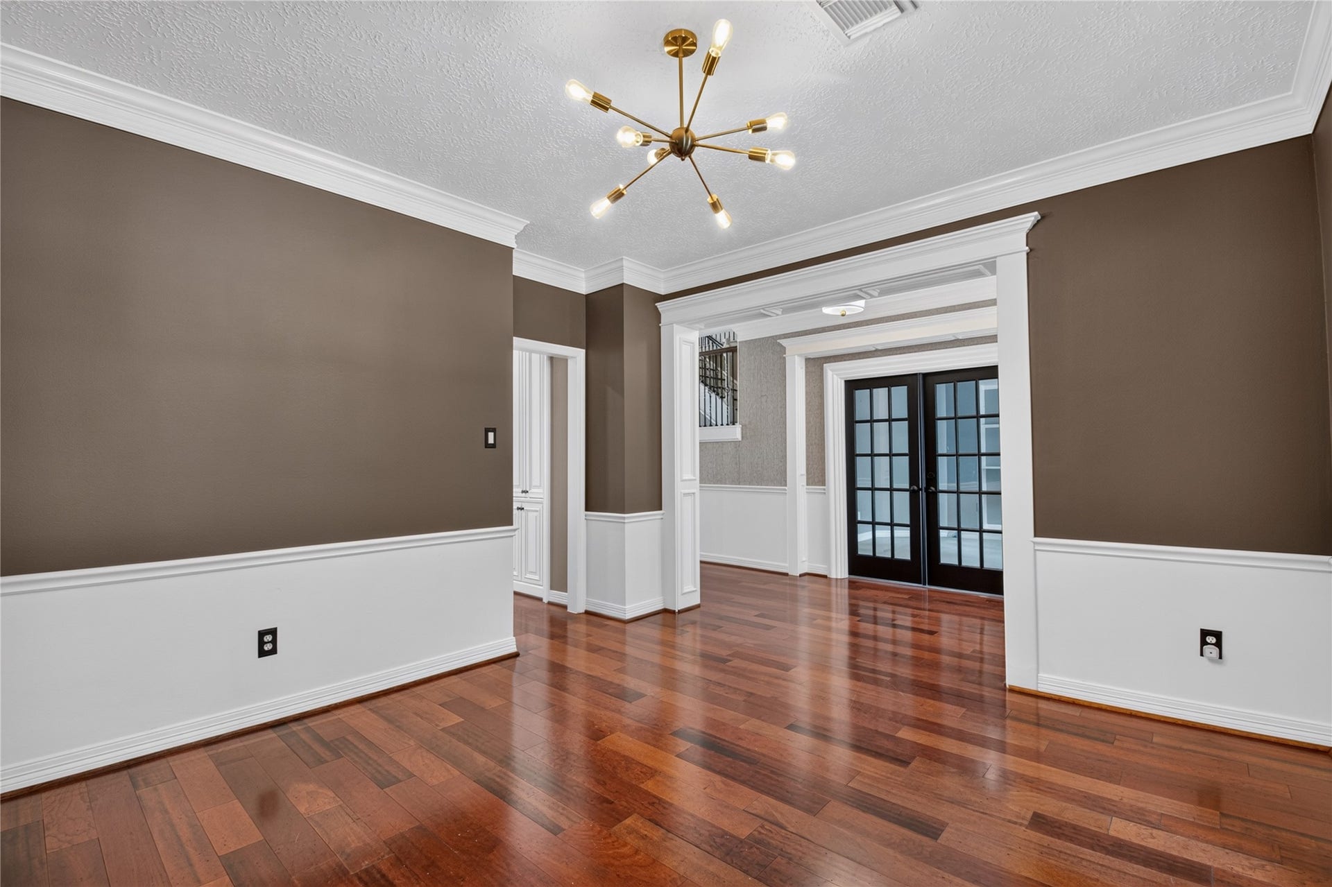 11810 Rue Beaujon Court, Tomball, TX 77377 The formal dining room features rich real wood floors, crown molding, and plenty of space for entertaining family and friends.