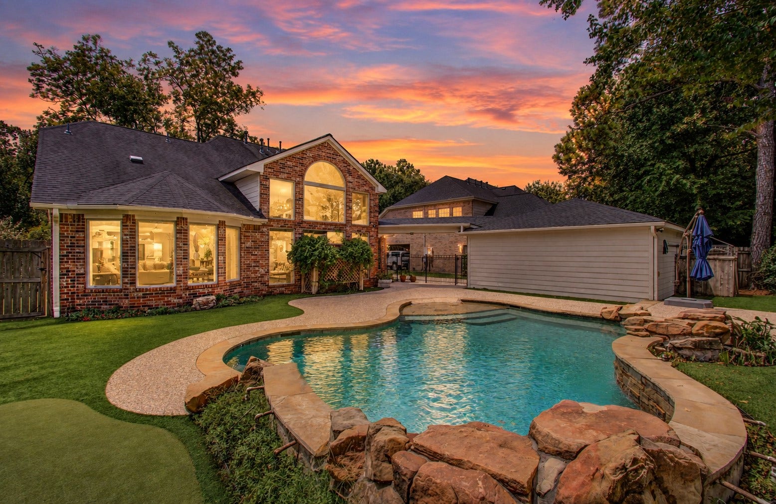 11810 Rue Beaujon Court, Tomball, TX 77377 PRIVATE BEACH-ENTRY PEBBLETEC POOL with rock waterfalls creates a backyard retreat made for Texas summers.