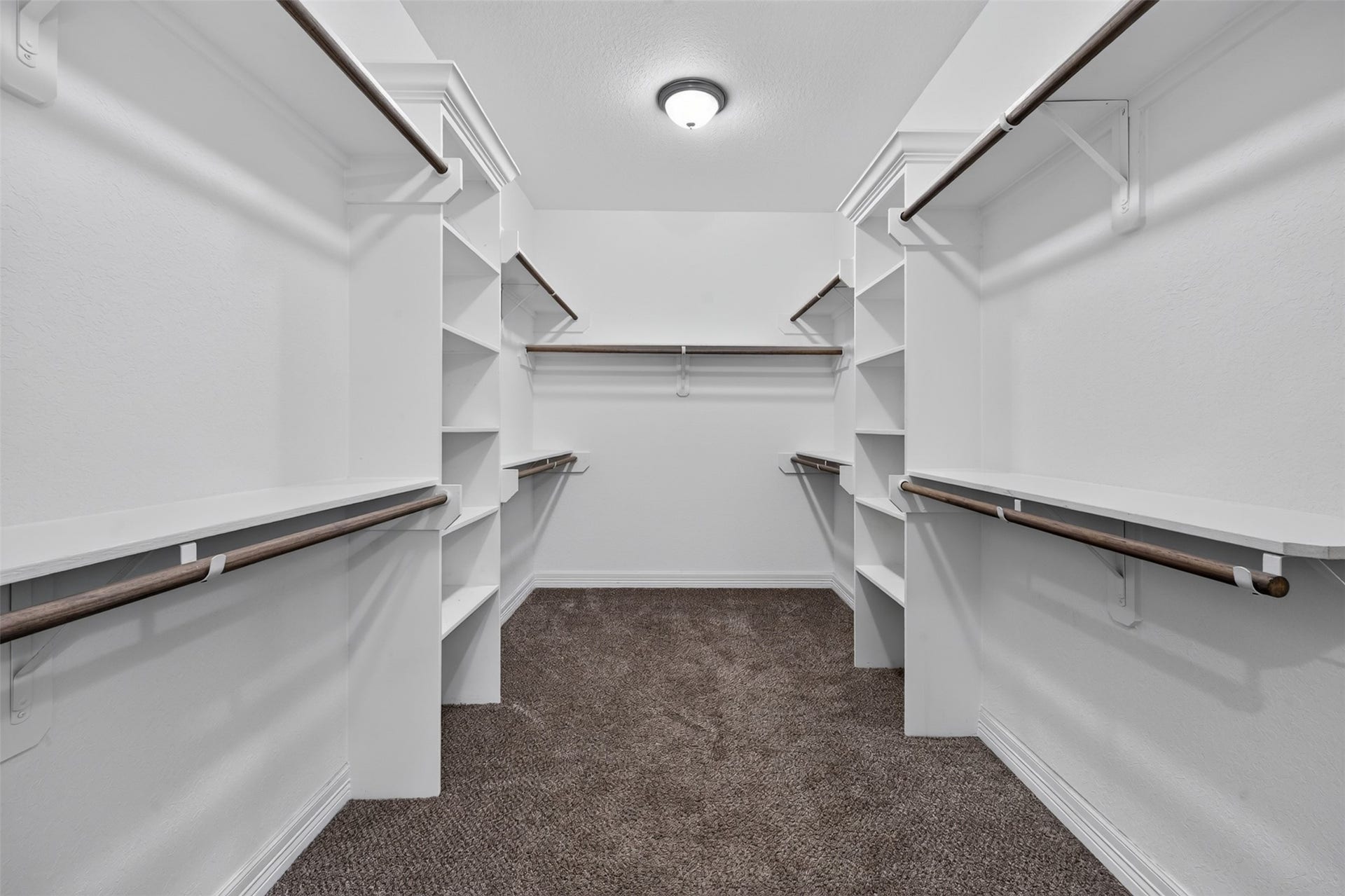Expansive walk-in closet featuring ample shelving and hanging space, perfectly designed for organized storage.