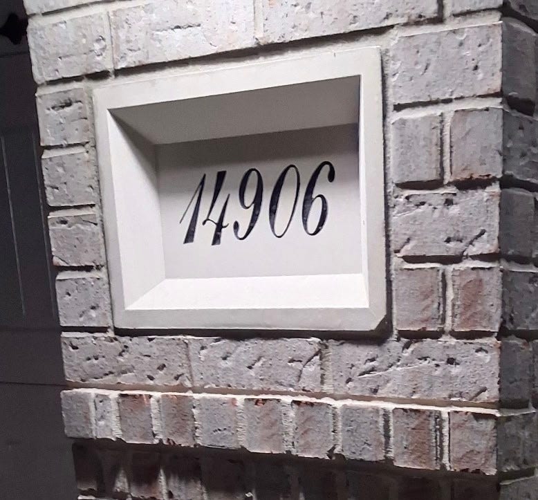Charming brick entryway with a stylishly recessed address plaque.