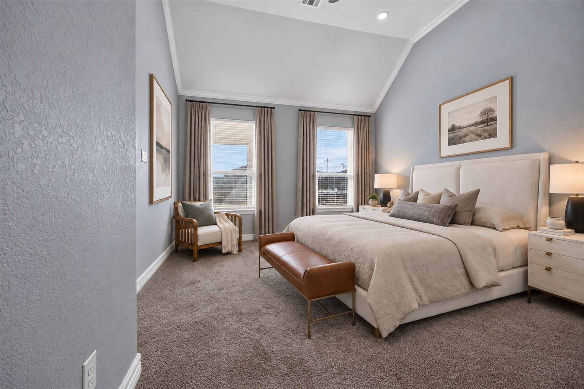 Elegant bedroom featuring a high ceiling, plush carpeting, and a large window that fills the space with natural light. The room includes a cozy seating area and stylish decor, creating a serene retreat.