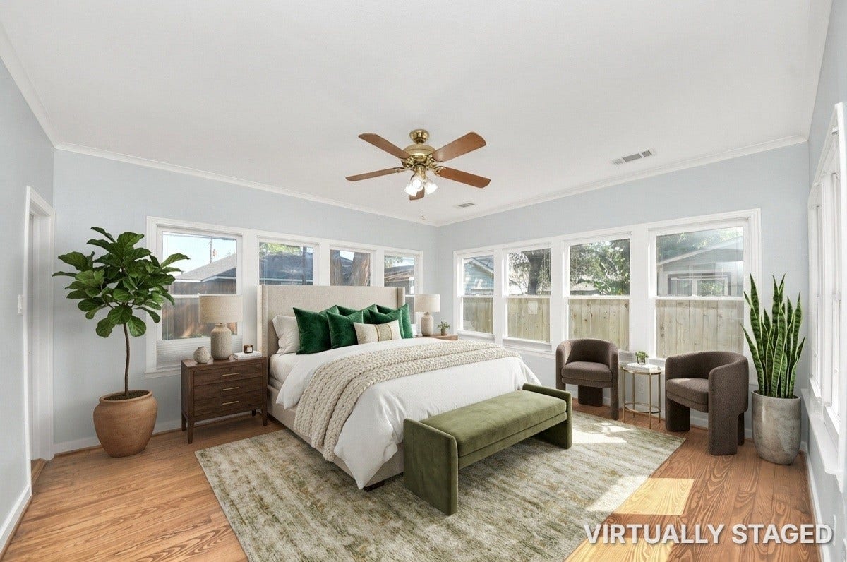 909 Fugate Street, Houston, TX 77009 Experience tranquility in this spacious primary bedroom, flooded with natural light and featuring stylish decor and ample space for relaxation.