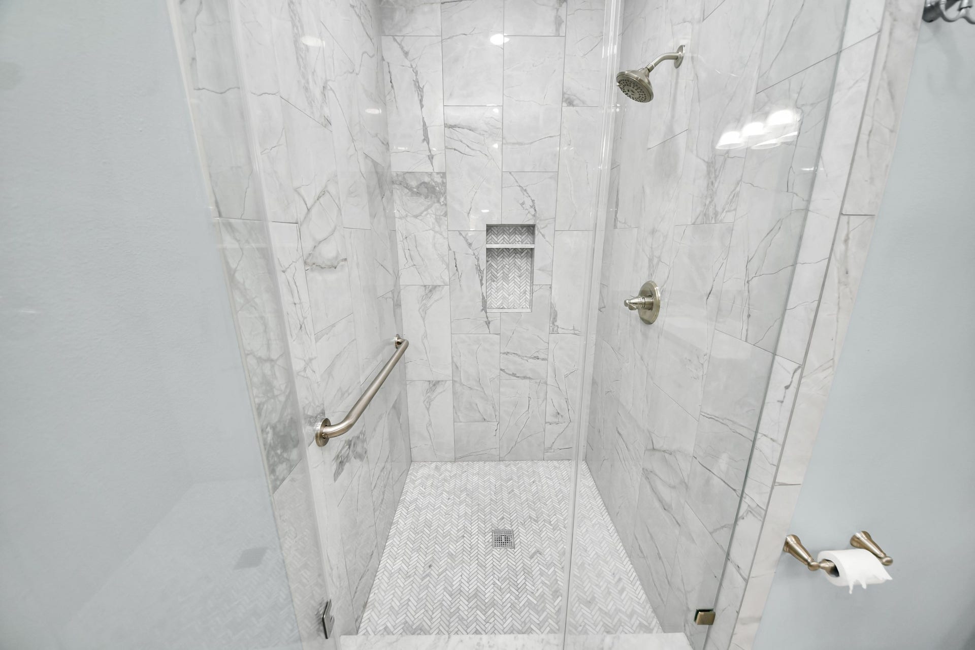 909 Fugate Street, Houston, TX 77009 Experience luxury in the fully updated secondary bathroom featuring elegant tile, a sleek glass shower, and modern fixtures for a spa-like retreat.