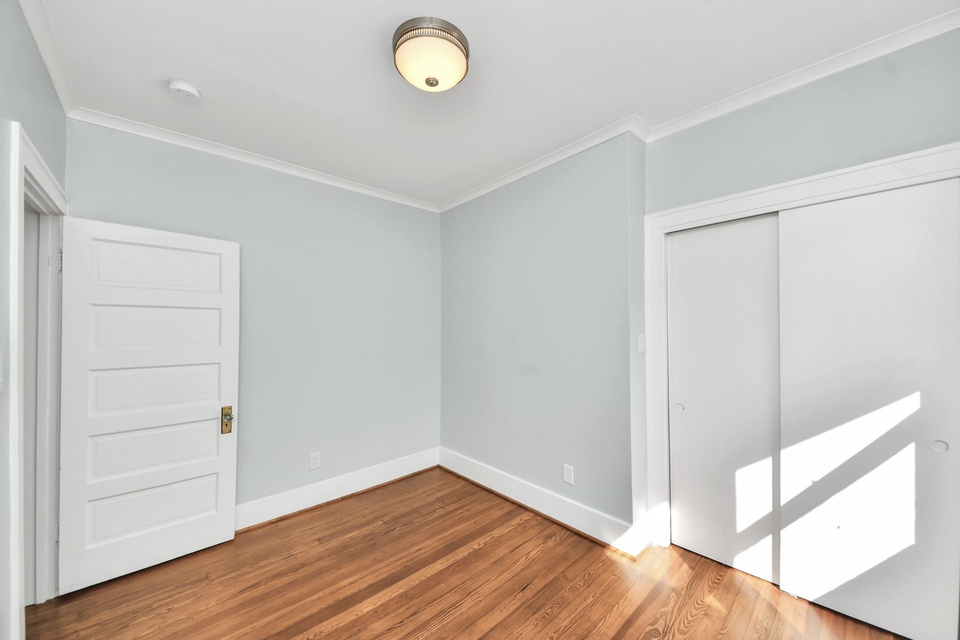 909 Fugate Street, Houston, TX 77009 Bright and inviting, Bedroom 2 features gleaming hardwood floors and ample natural light, creating a serene retreat.