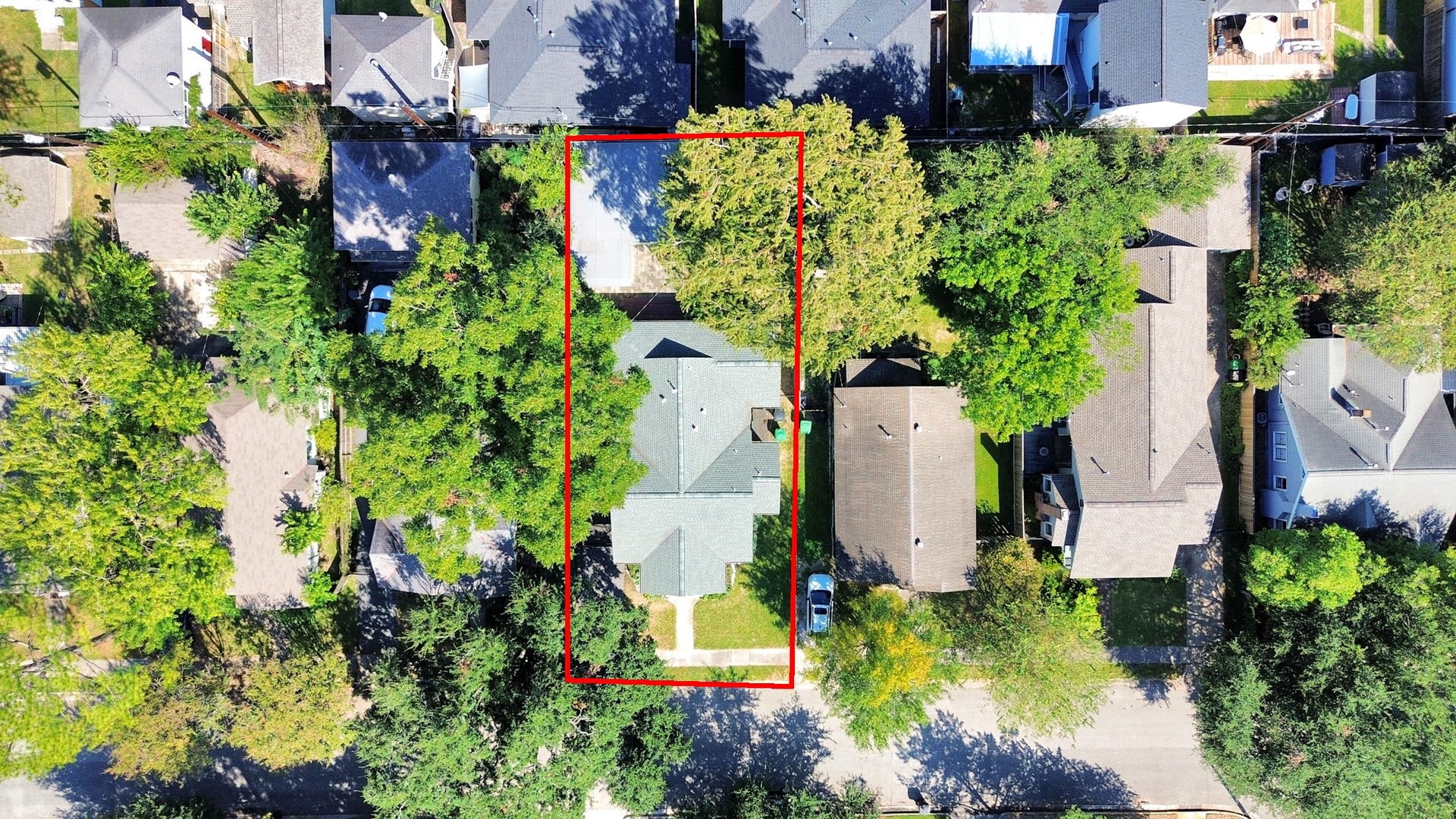 909 Fugate Street, Houston, TX 77009 Aerial view of a charming home nestled among mature trees, offering privacy and a lush green setting in a vibrant neighborhood.