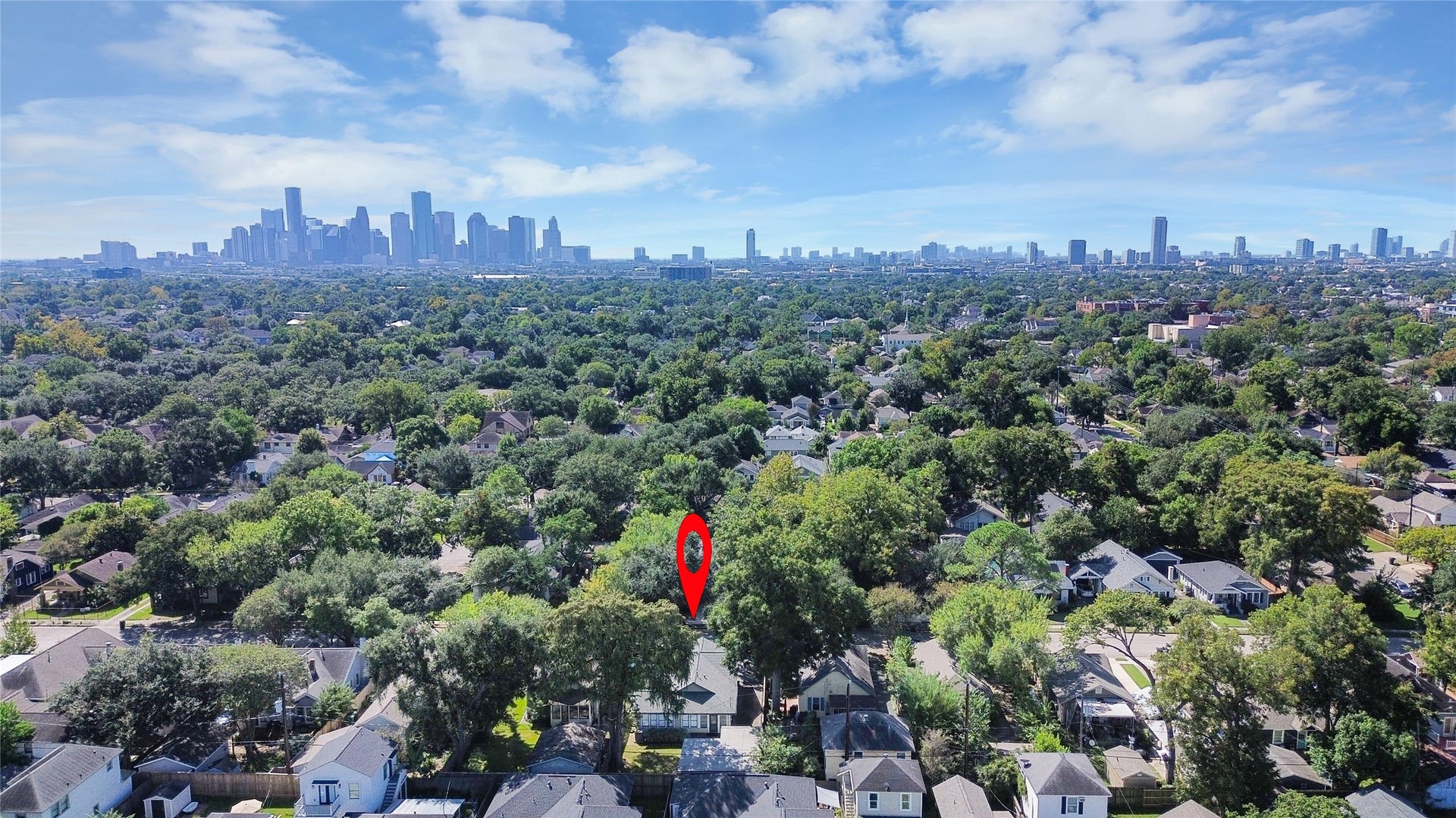 909 Fugate Street, Houston, TX 77009 Nestled in a lush, tree-lined neighborhood, this home offers a serene escape with the vibrant city skyline as a stunning backdrop.