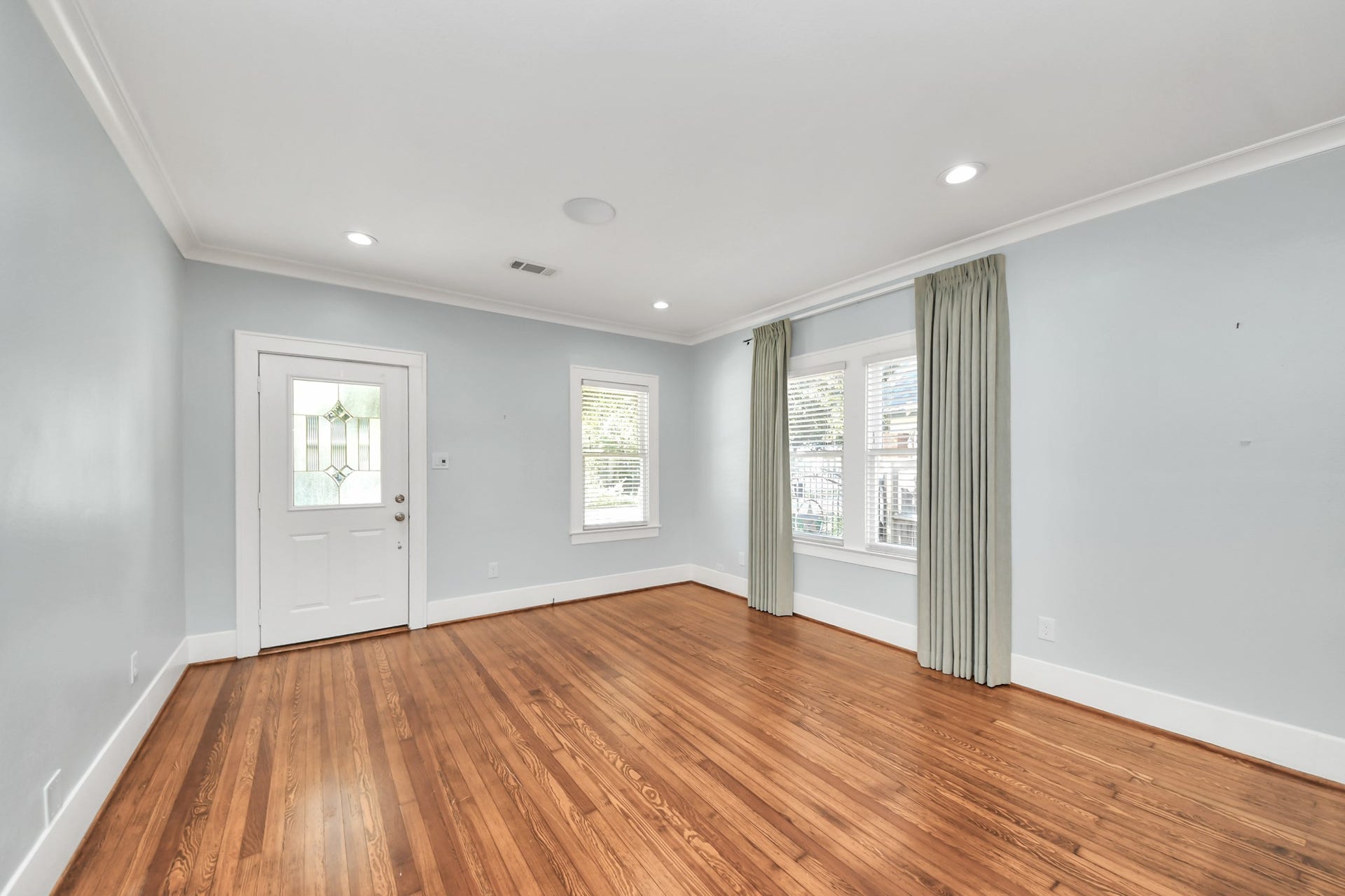 909 Fugate Street, Houston, TX 77009 Step into an inviting foyer entry with gleaming hardwood floors and abundant natural light, setting the tone for a warm and welcoming home.