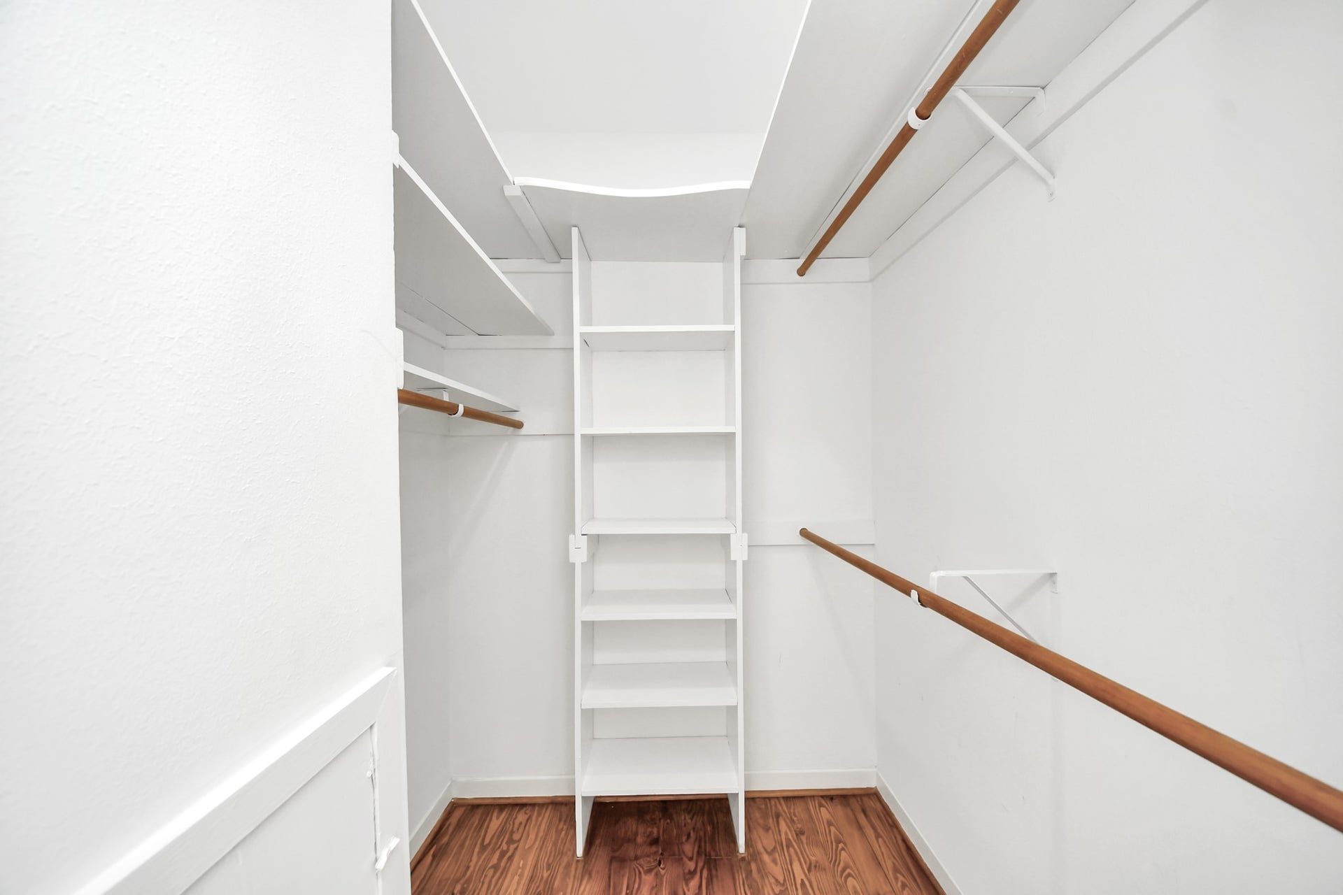 909 Fugate Street, Houston, TX 77009 Discover the spacious elegance of the primary closet, offering ample shelving and hanging space to effortlessly organize your wardrobe.