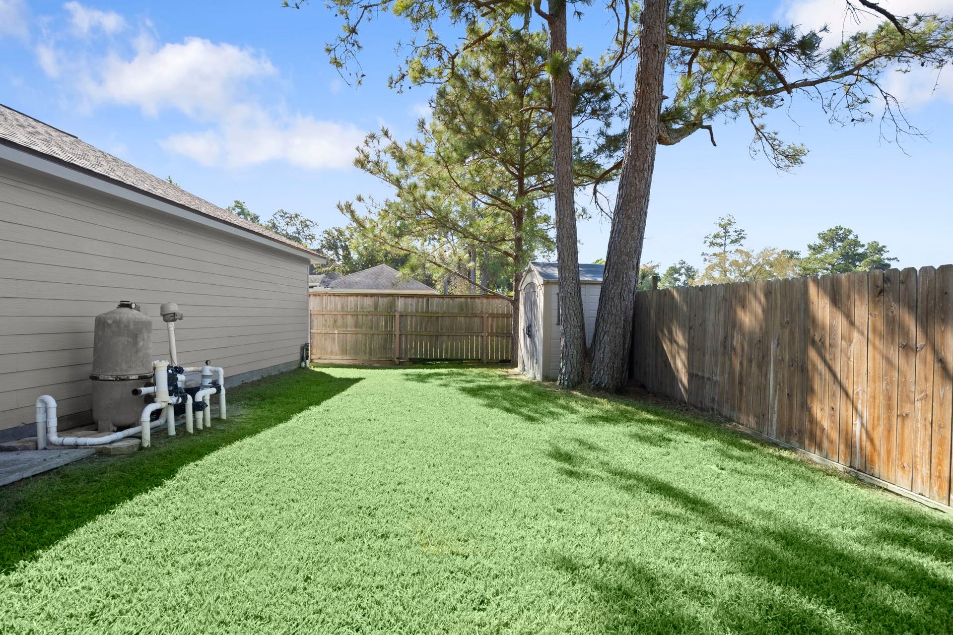 24815 Giltspur Way, Spring, TX 77389 STORAGE GALORE & NO BACK NEIGHBORS! Spacious 3-car garage with durable, low-maintenance Hardie siding, known for its resistance to rot, pests, and weather. Pool equipment is tucked along the shaded side of the garage, while a separate storage shed keeps pool supplies, lawn equipment, and gardening essentials organized. As if a 3-car garage weren't enough! Enjoy mature trees, lush lawn, and added privacy with green space beyond the rear fence. ROOM TO BREATHE!