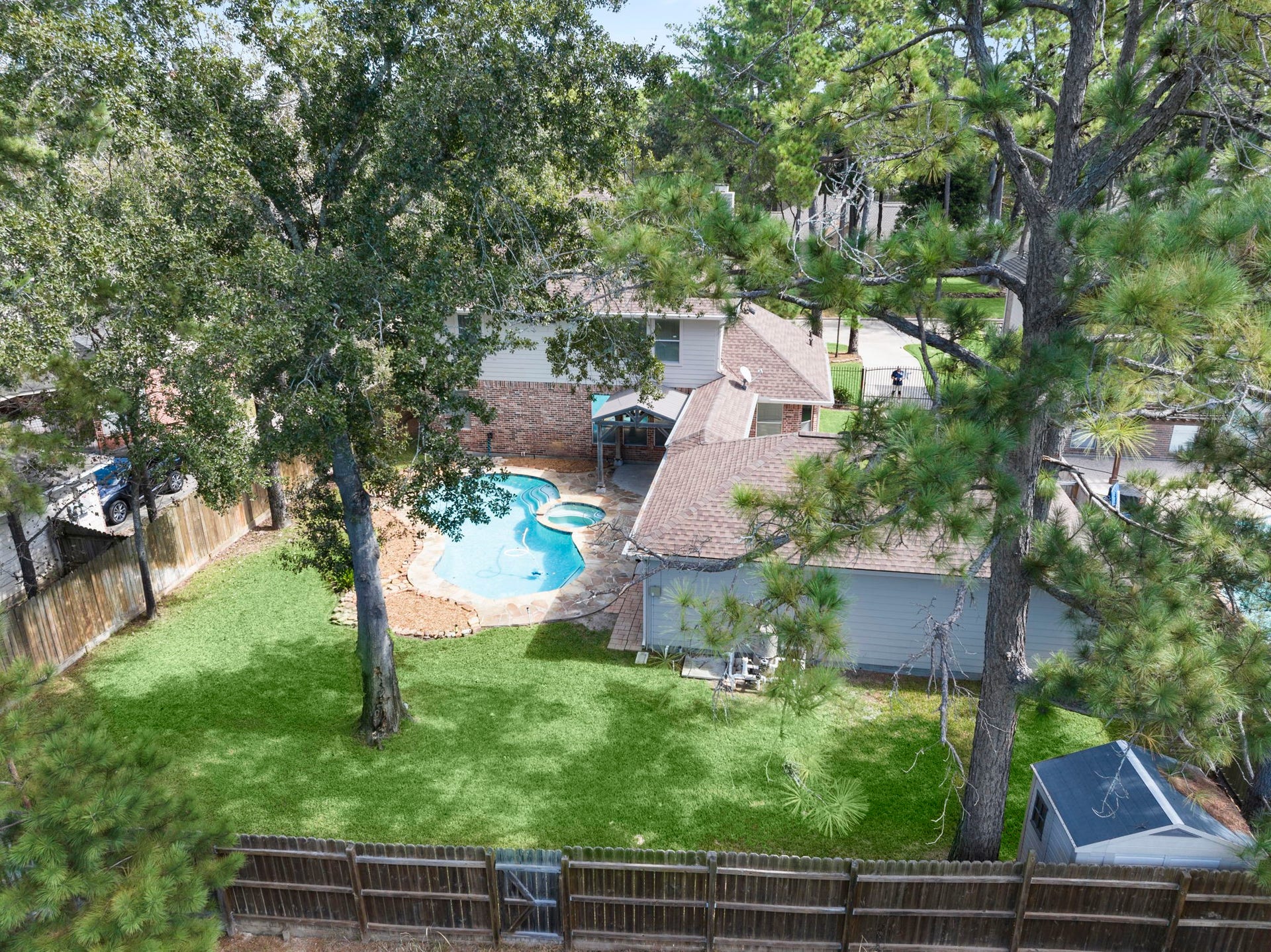 24815 Giltspur Way, Spring, TX 77389 A RARE FIND! Enjoy the privacy of a greenbelt setting with NO REAR NEIGHBORS! This beautiful property features an expansive backyard, sparkling pool, and an extra-long gated driveway leading to a detached 3-car garage, and a covered walkway connecting the garage to the home. AND THIS IS JUST A SNEAK PEEK! Keep scrolling...the best is yet to come!