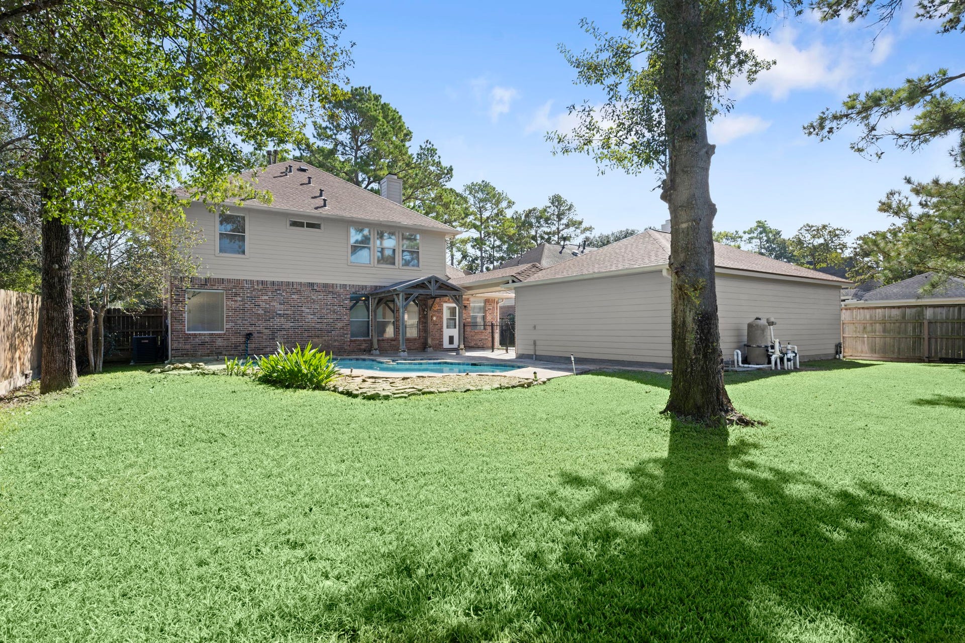 24815 Giltspur Way, Spring, TX 77389 YOUR PRIVATE BACKYARD OASIS! Sparkling freeform pool, mature shade trees, lush landscaping, and plenty of green space for Fido, a playset, or family gatherings! Attractive brick and Hardie siding exterior, newer roof, and LeafGuard gutters offer added peace of mind. Outdoor living at its finest!